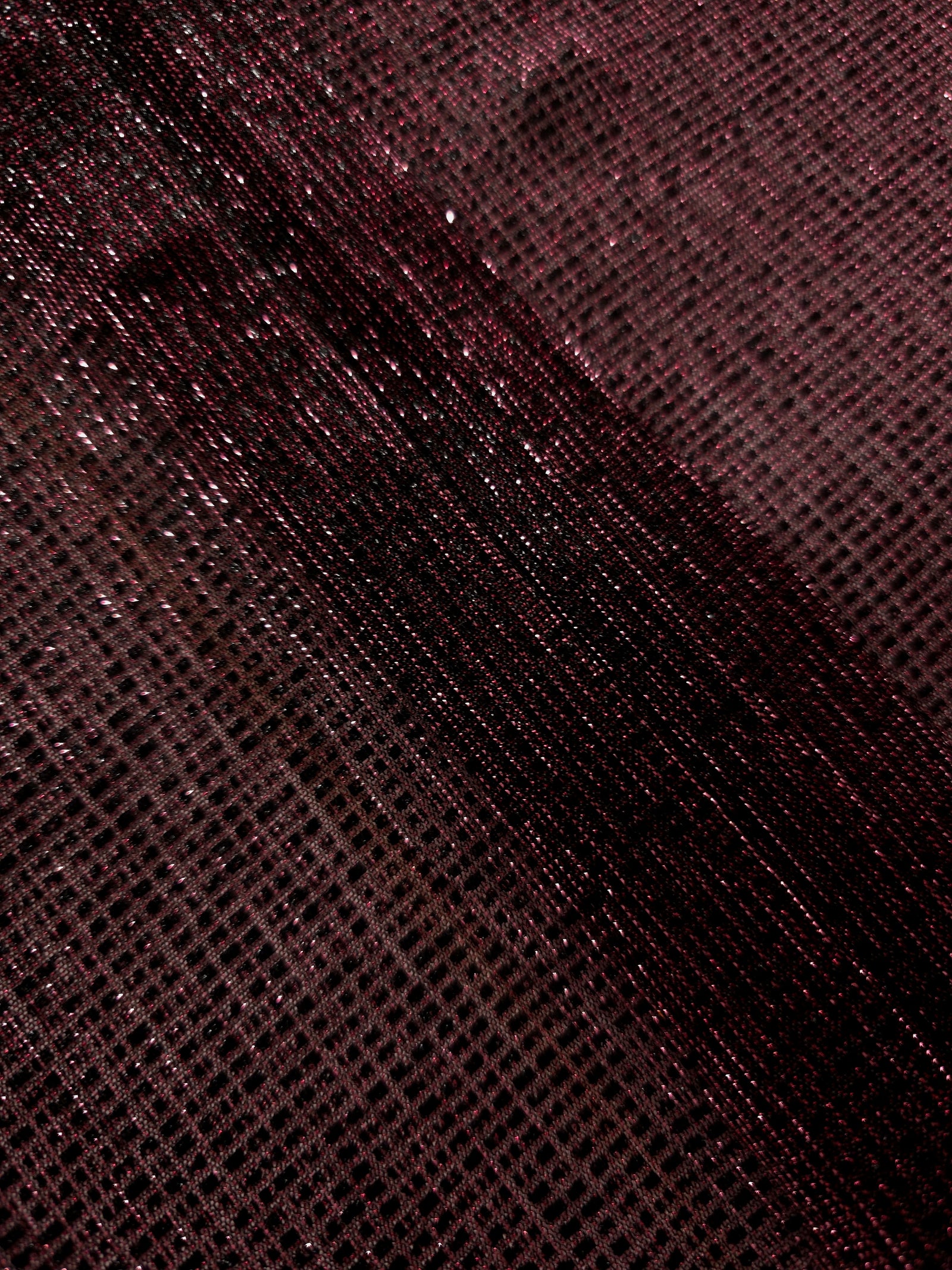Swirl-draped Dark Pink Sheer Square Shimmer Stretch Tulle Fabric showing structured square reflections moving through soft folds
