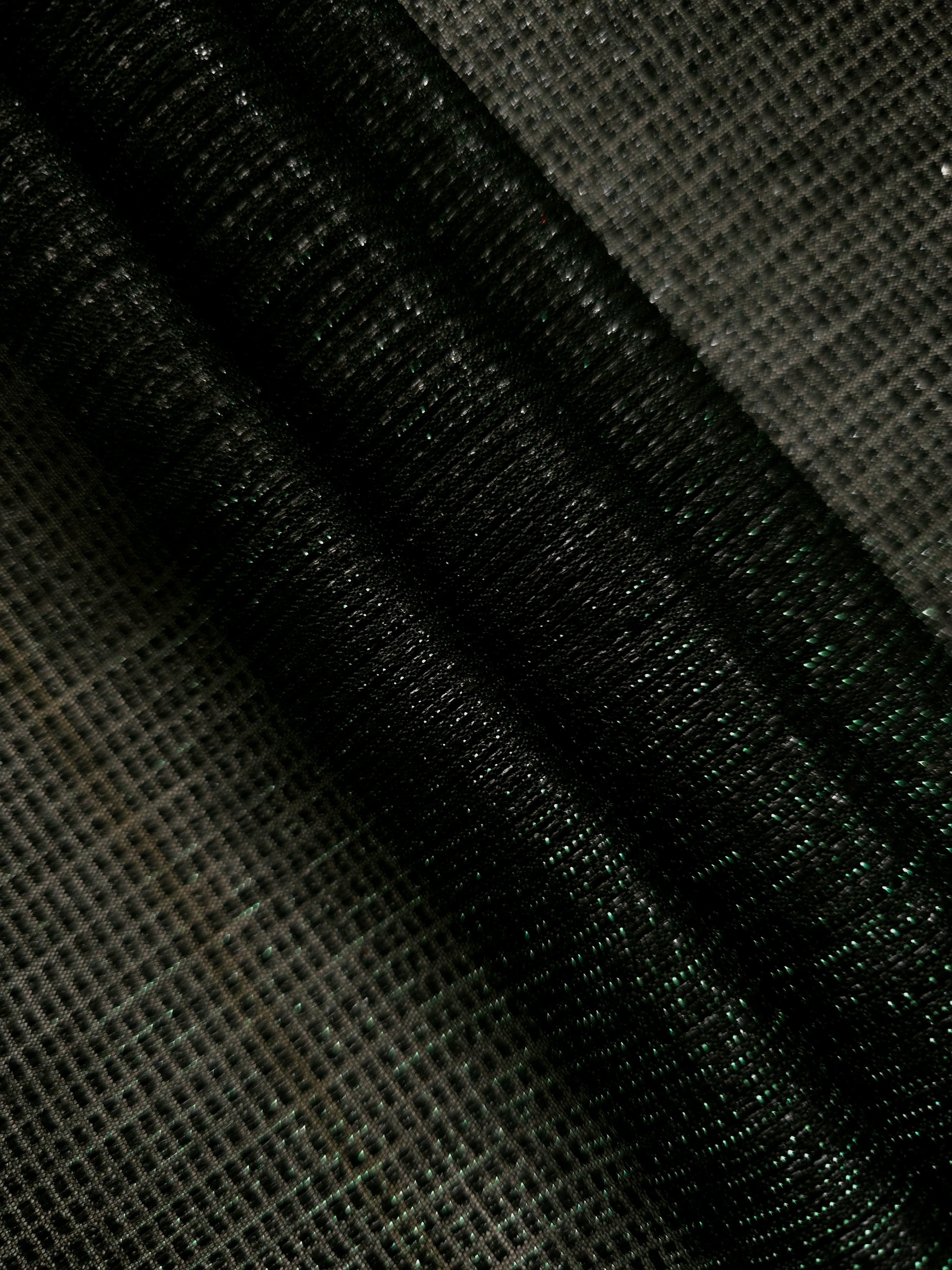 Layered Deep Emerald Sheer Square Shimmer Stretch Tulle Fabric showing overlapping geometry, denser shimmer and translucent depth