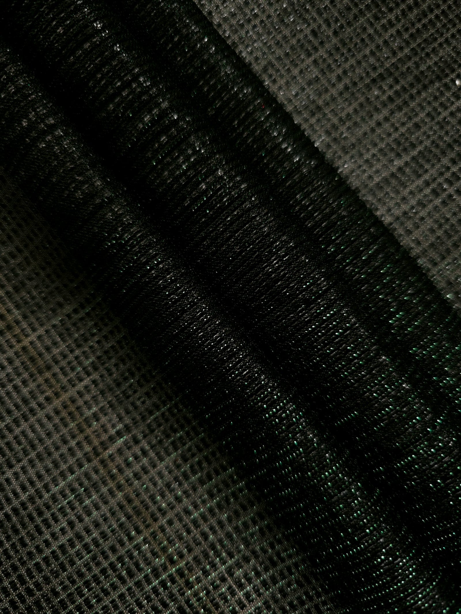 Layered Deep Emerald Sheer Square Shimmer Stretch Tulle Fabric showing overlapping geometry, denser shimmer and translucent depth