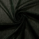 Swirl-draped Deep Emerald Sheer Square Shimmer Stretch Tulle Fabric showing structured square reflections moving through soft folds
