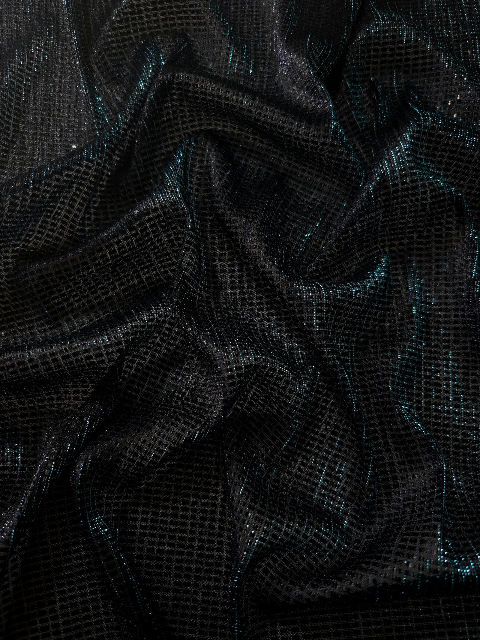 Draped Deep Teal Sheer Square Shimmer Stretch Tulle Fabric showing a geometric reflective grid across fluid folds