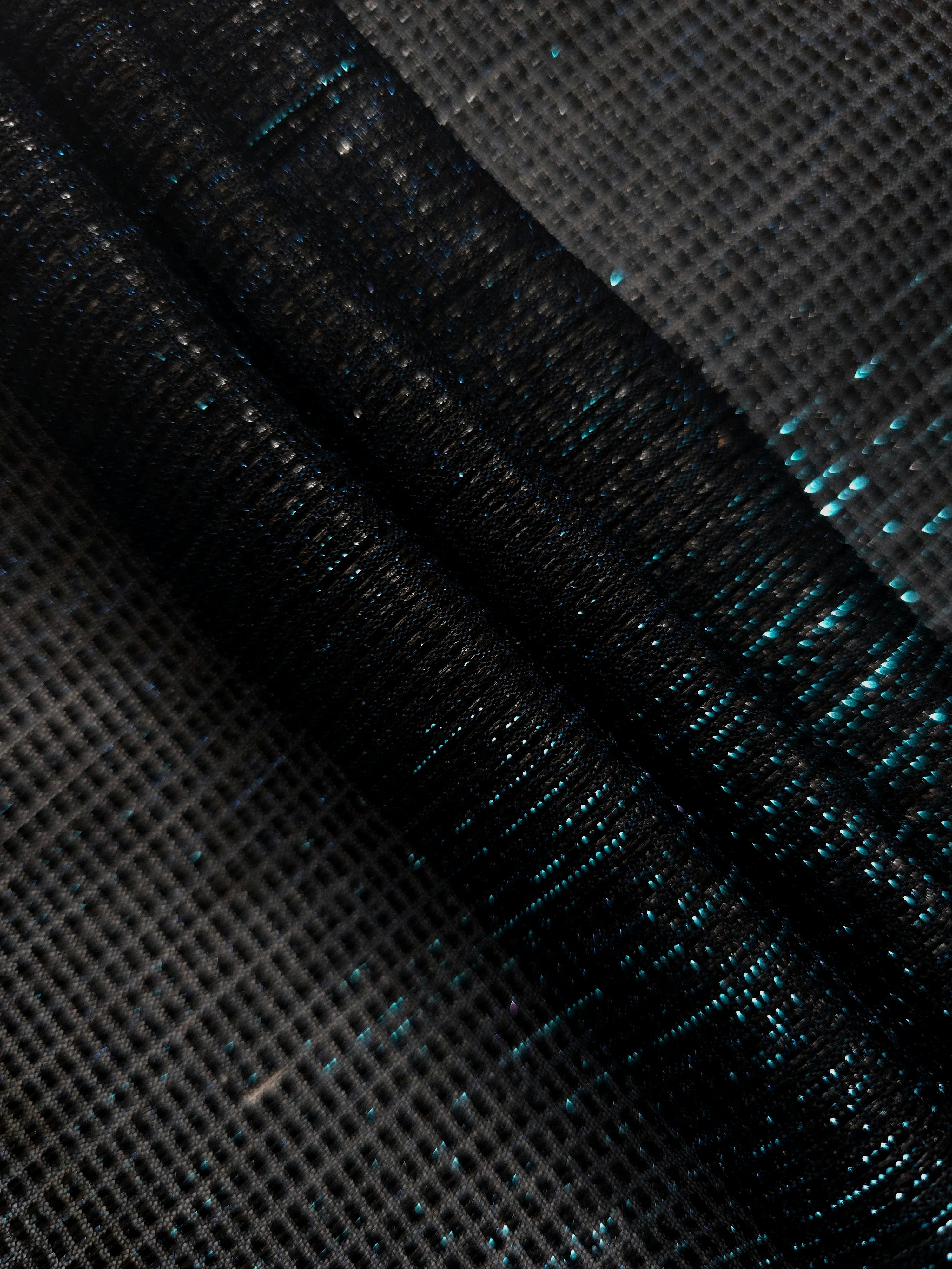 Layered Deep Teal Sheer Square Shimmer Stretch Tulle Fabric showing overlapping geometry, denser shimmer and translucent depth