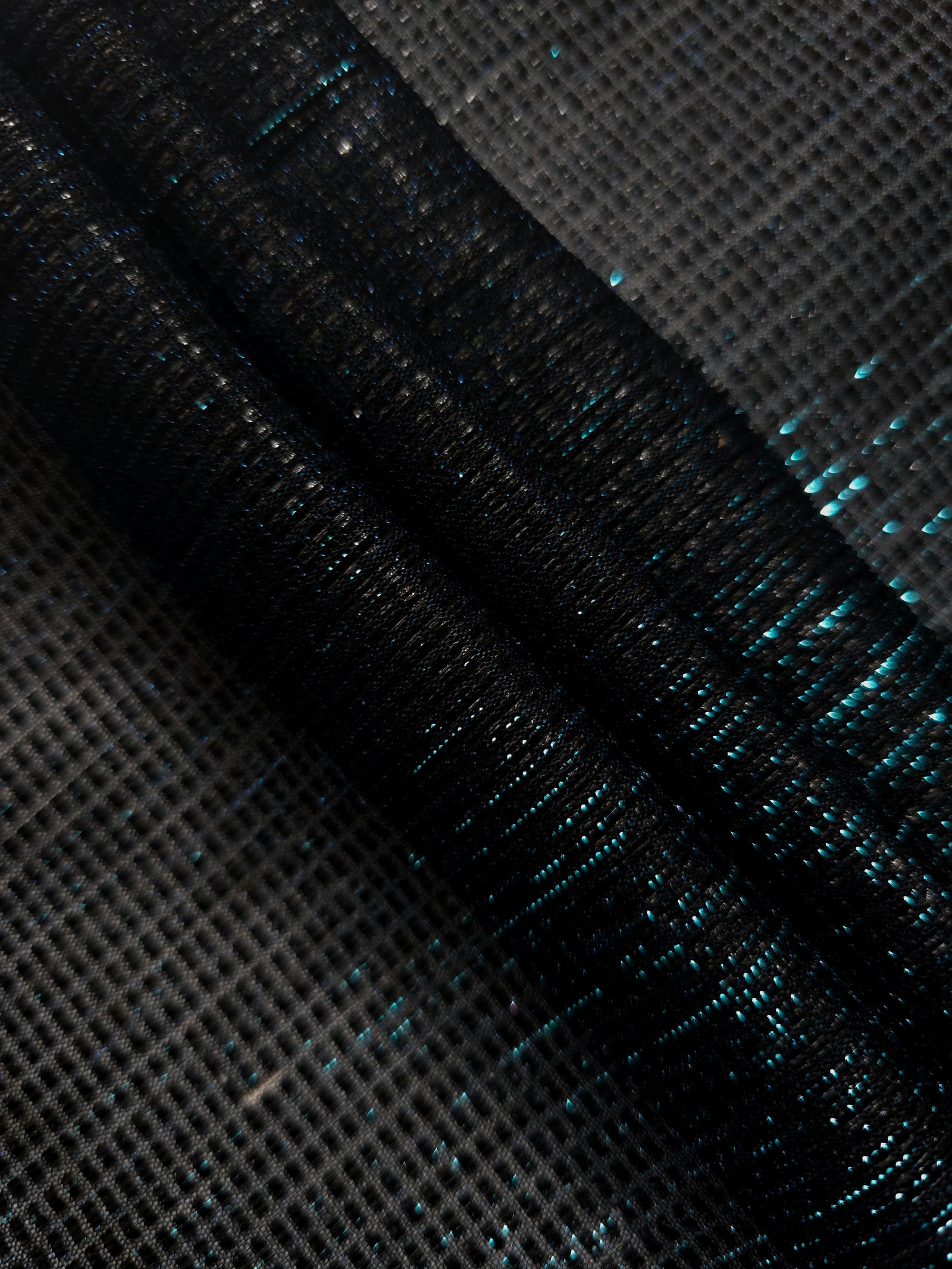 Layered Deep Teal Sheer Square Shimmer Stretch Tulle Fabric showing overlapping geometry, denser shimmer and translucent depth