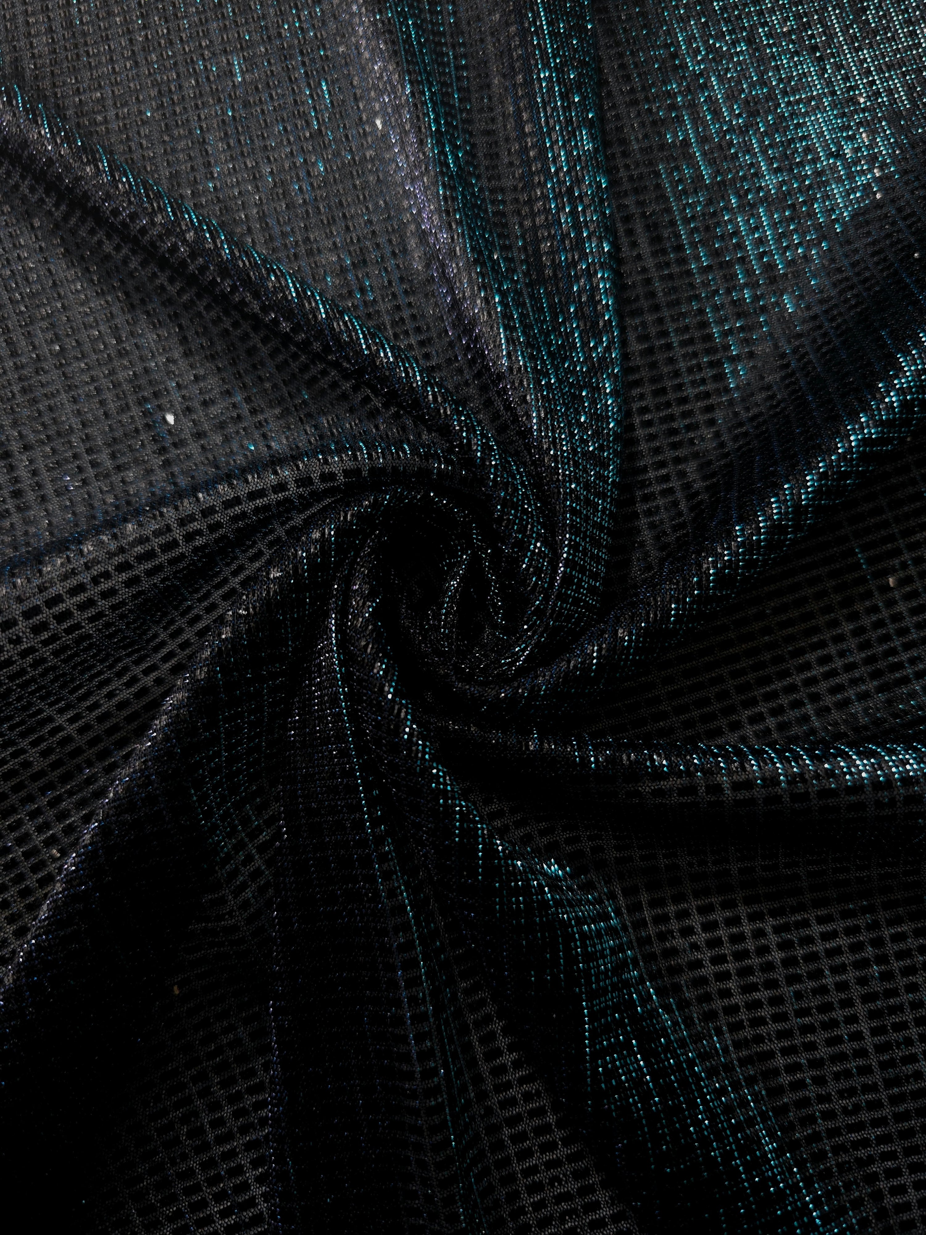 Swirl-draped Deep Teal Sheer Square Shimmer Stretch Tulle Fabric showing structured square reflections moving through soft folds