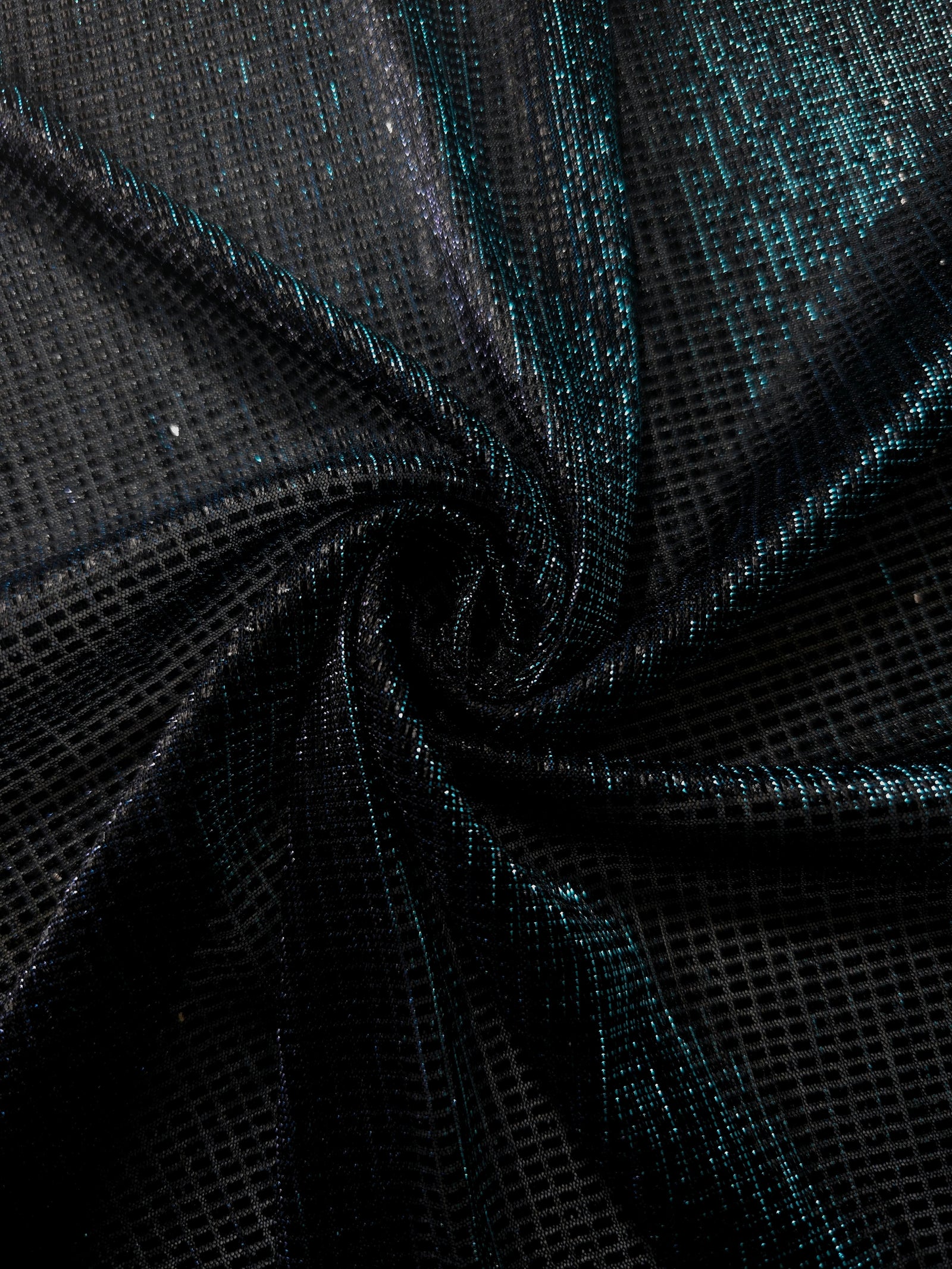 Swirl-draped Deep Teal Sheer Square Shimmer Stretch Tulle Fabric showing structured square reflections moving through soft folds