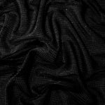 Draped Jet Black Sheer Square Shimmer Stretch Tulle Fabric showing a geometric reflective grid across fluid folds