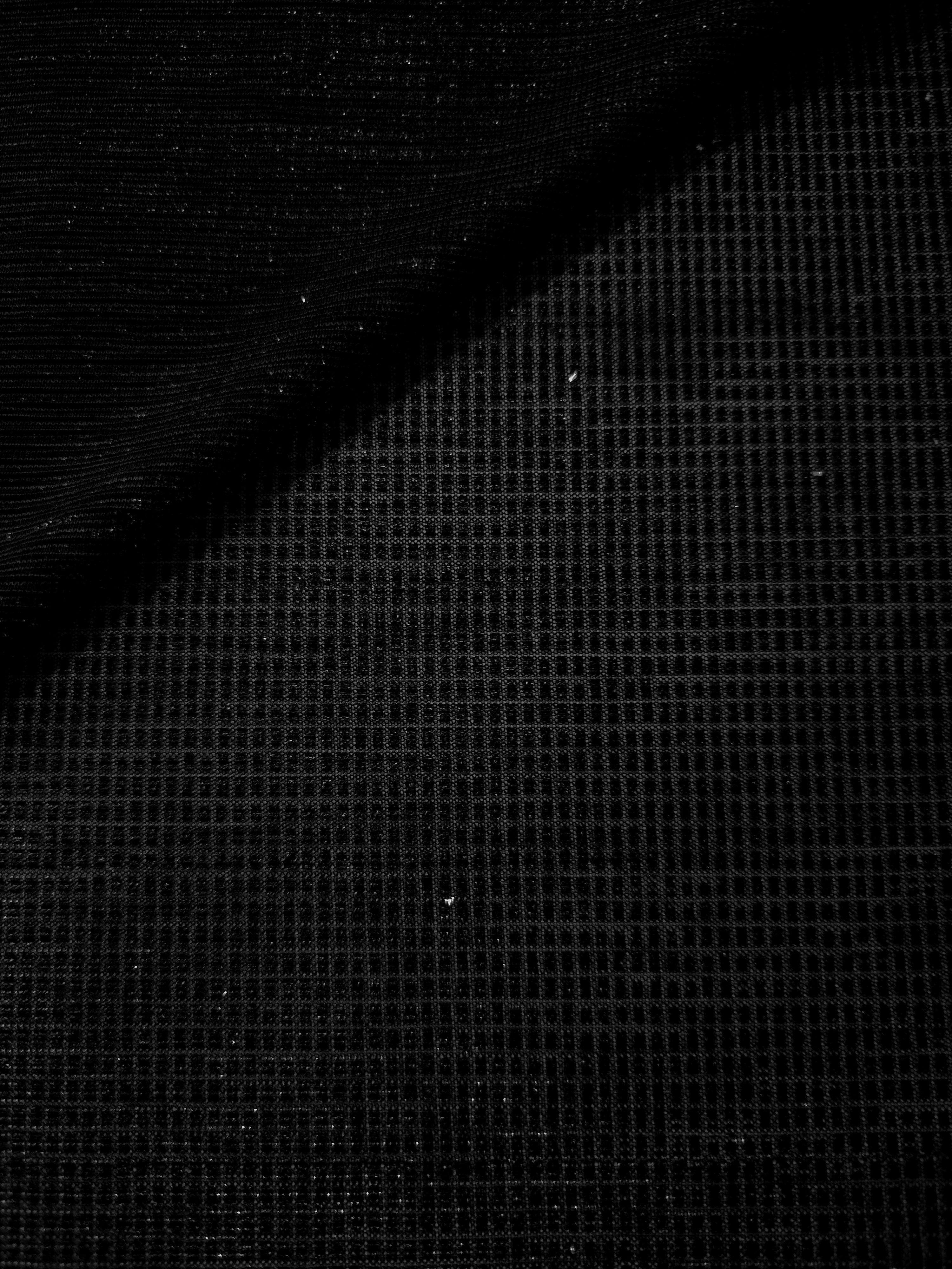 Front and back of Jet Black Sheer Square Shimmer Stretch Tulle Fabric showing square motif, sheer knit base and flexible stretch