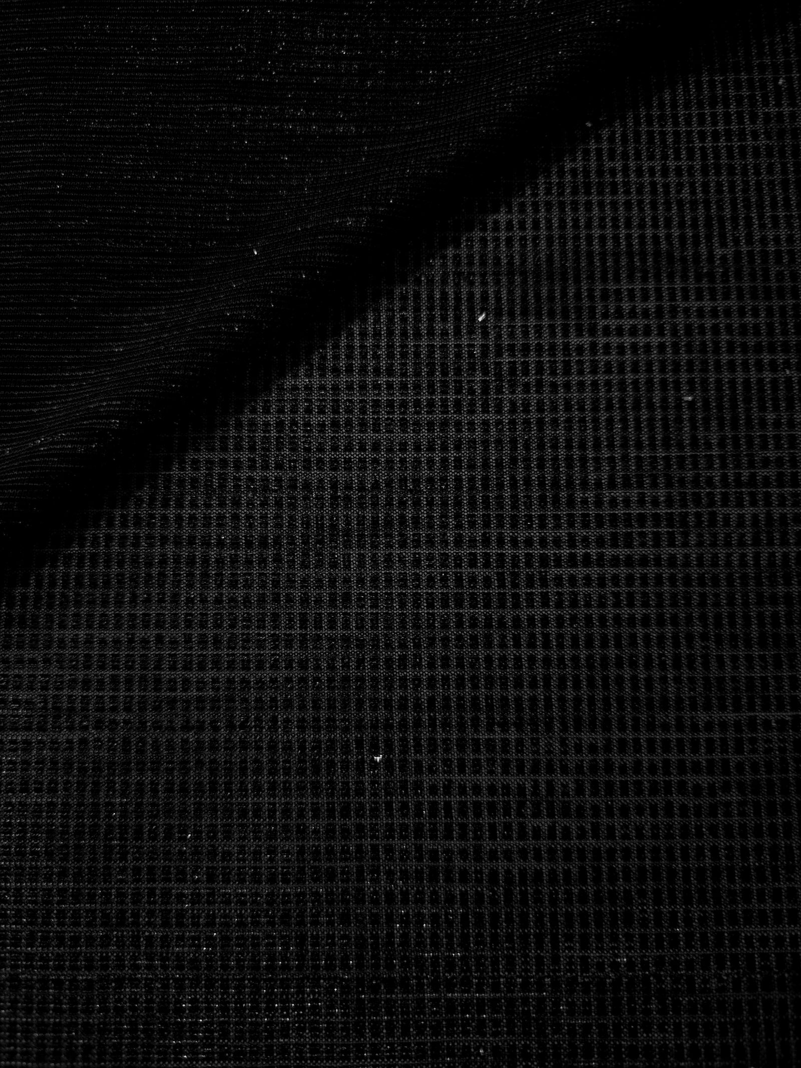 Front and back of Jet Black Sheer Square Shimmer Stretch Tulle Fabric showing square motif, sheer knit base and flexible stretch