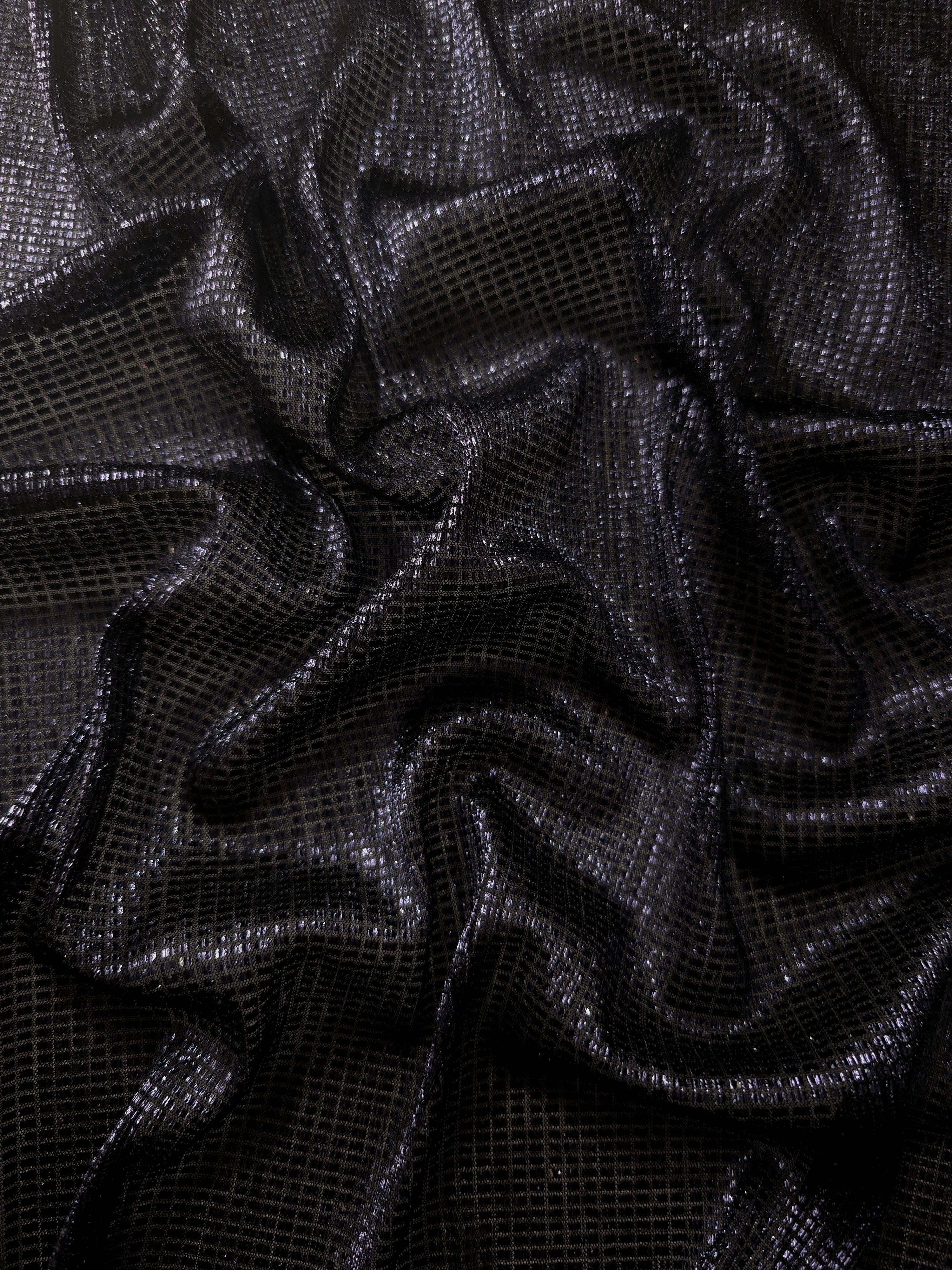 Draped Midnight Indigo Sheer Square Shimmer Stretch Tulle Fabric showing a geometric reflective grid across fluid folds