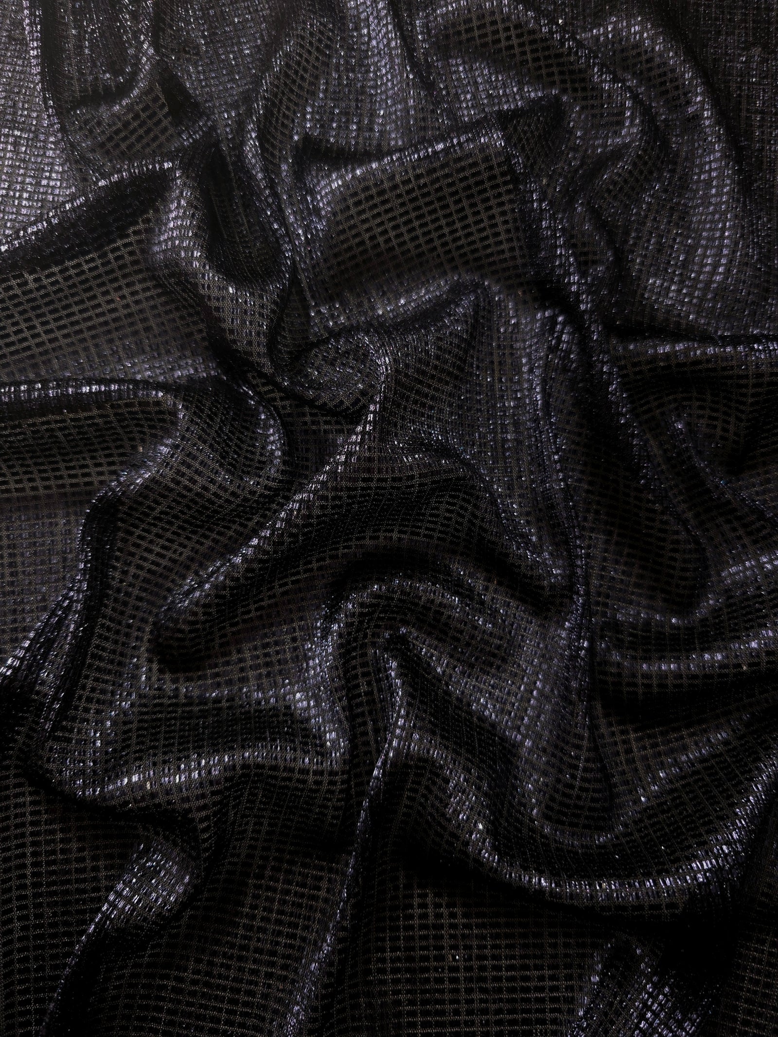 Draped Midnight Indigo Sheer Square Shimmer Stretch Tulle Fabric showing a geometric reflective grid across fluid folds