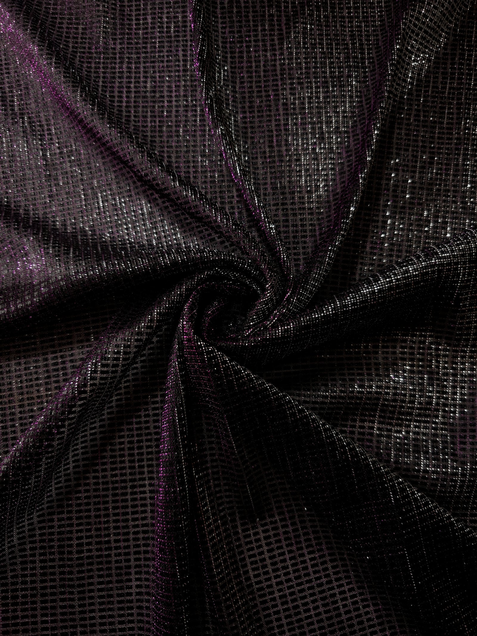 Draped Plum Violet Sheer Square Shimmer Stretch Tulle Fabric showing a geometric reflective grid across fluid folds