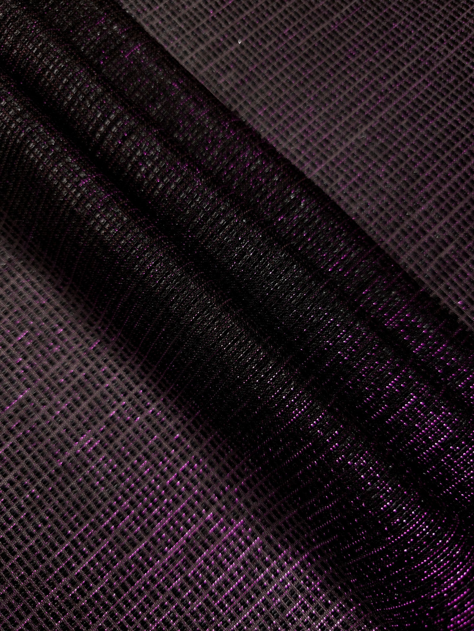 Swirl-draped Plum Violet Sheer Square Shimmer Stretch Tulle Fabric showing structured square reflections moving through soft folds