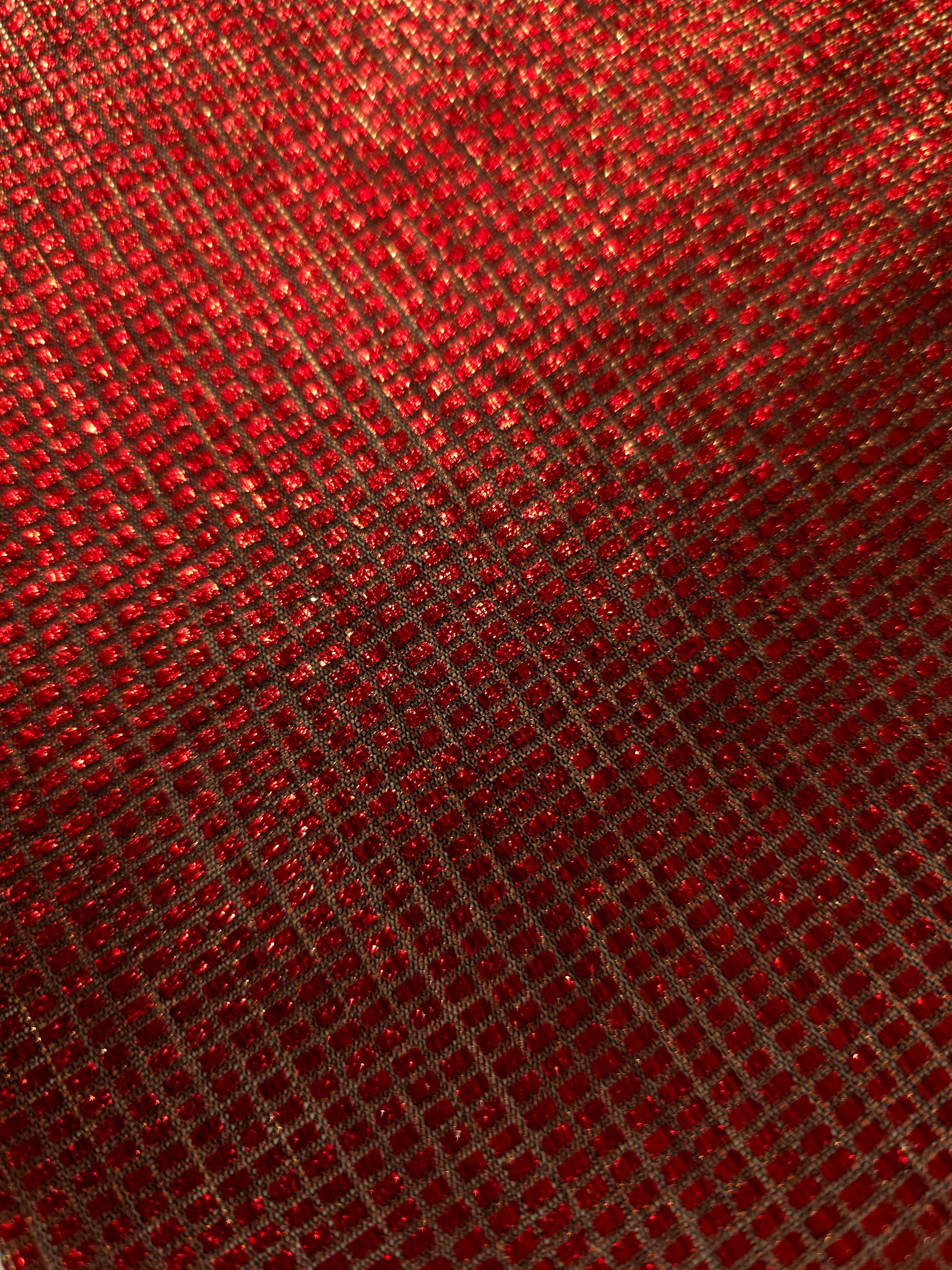 Close-up of Ruby Red Sheer Square Shimmer Stretch Tulle Fabric revealing the square shimmer repeat and fine transparent mesh