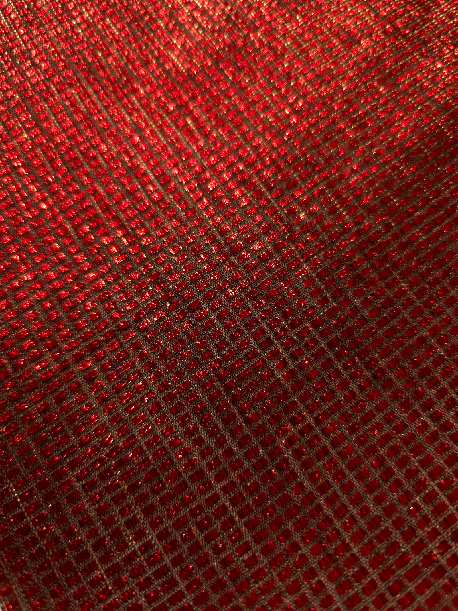 Close-up of Ruby Red Sheer Square Shimmer Stretch Tulle Fabric revealing the square shimmer repeat and fine transparent mesh
