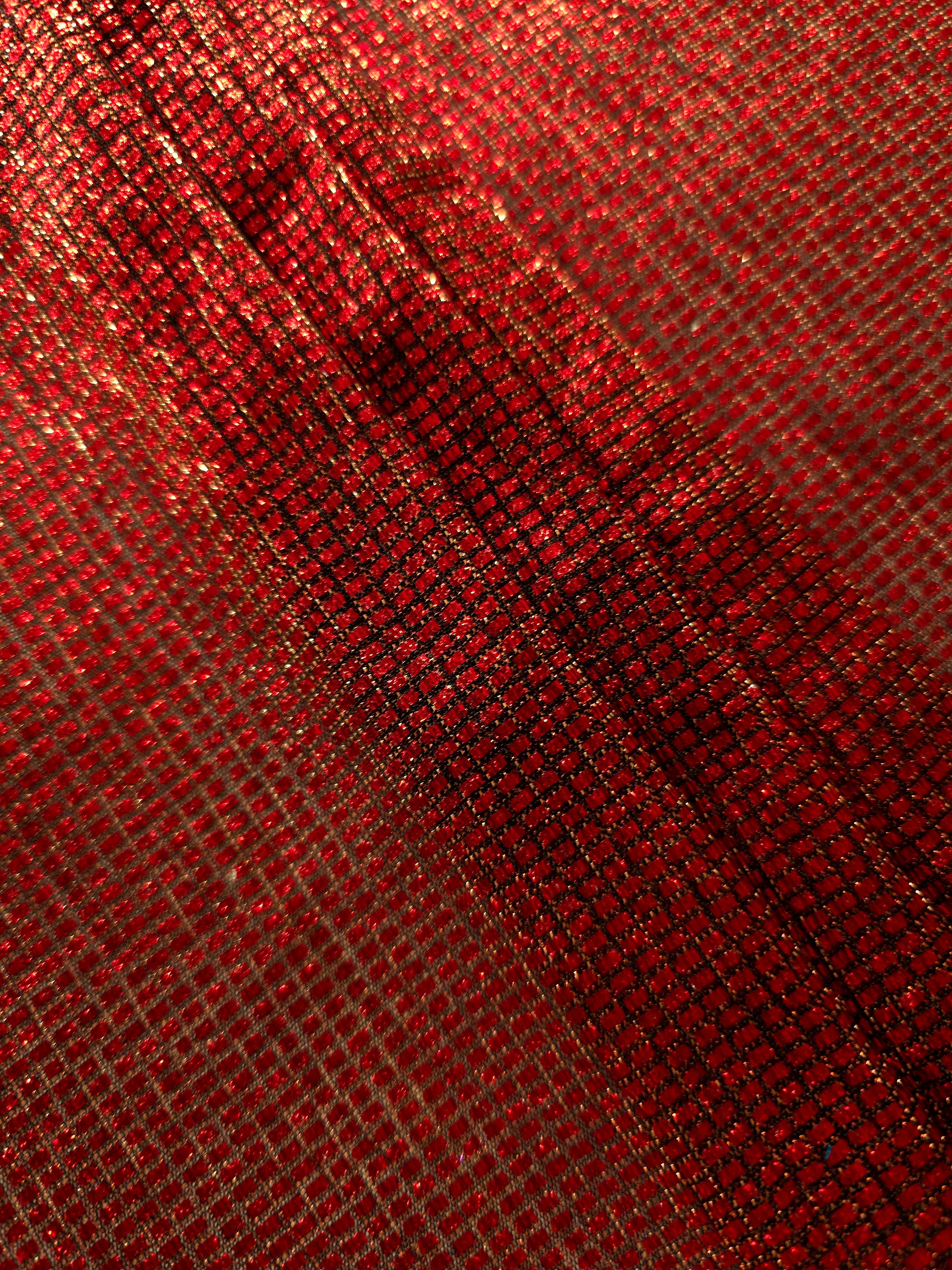 Layered Ruby Red Sheer Square Shimmer Stretch Tulle Fabric showing overlapping geometry, denser shimmer and translucent depth