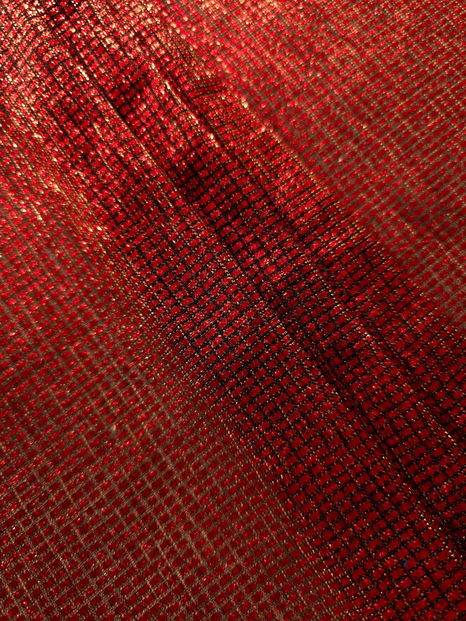 Layered Ruby Red Sheer Square Shimmer Stretch Tulle Fabric showing overlapping geometry, denser shimmer and translucent depth