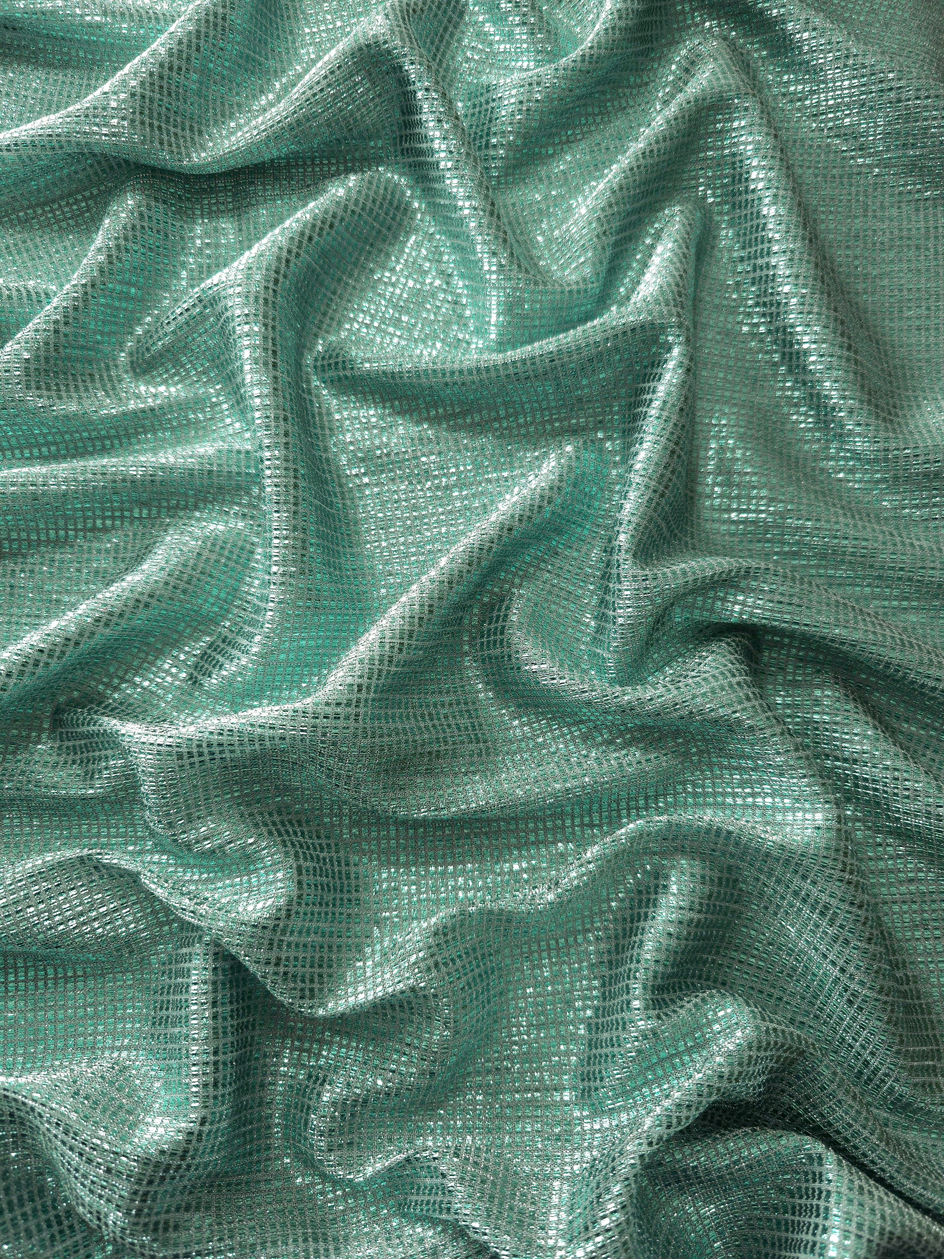 Draped Sage Green Sheer Square Shimmer Stretch Tulle Fabric showing a geometric reflective grid across fluid folds