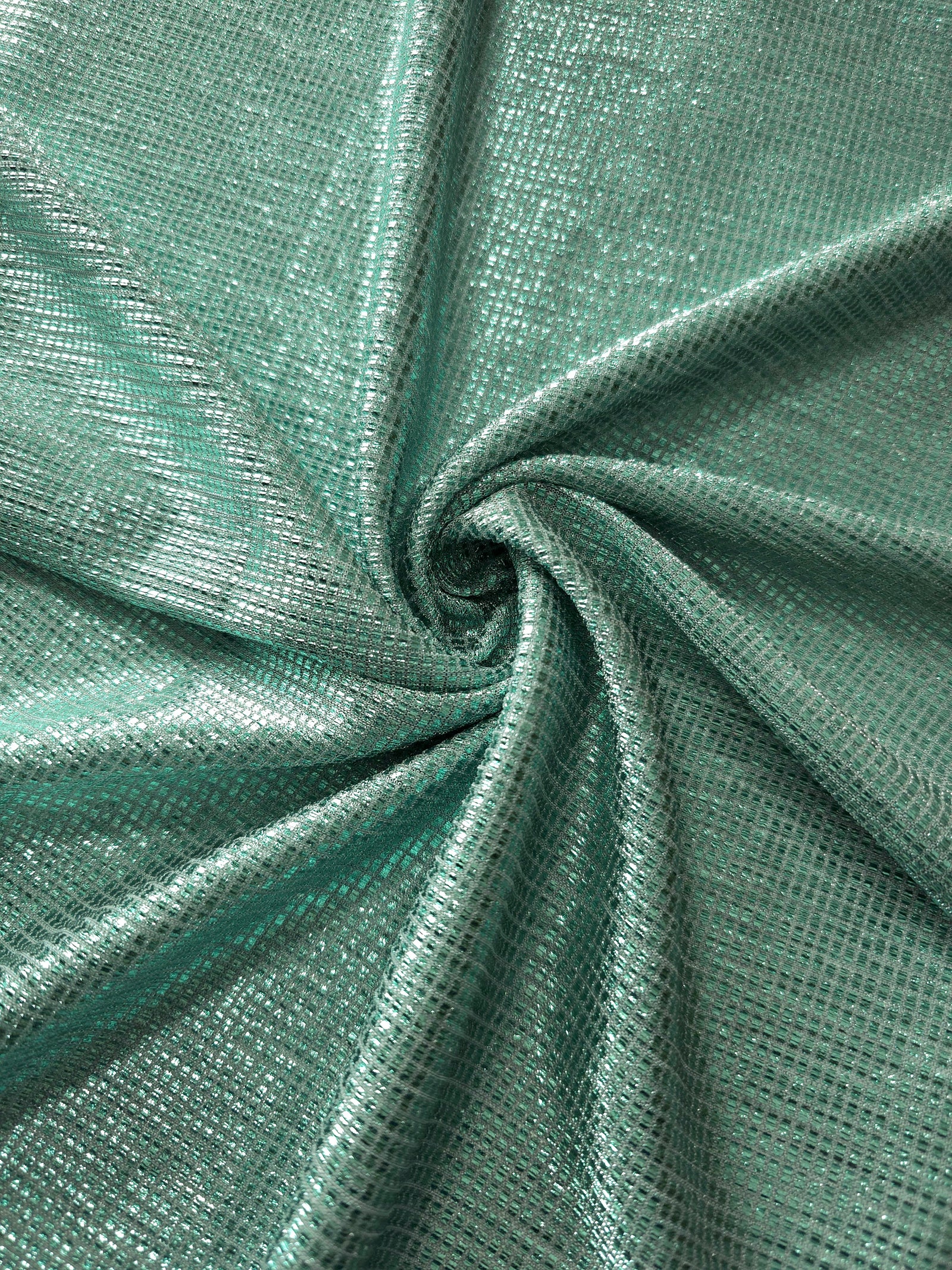 Swirl-draped Sage Green Sheer Square Shimmer Stretch Tulle Fabric showing structured square reflections moving through soft folds