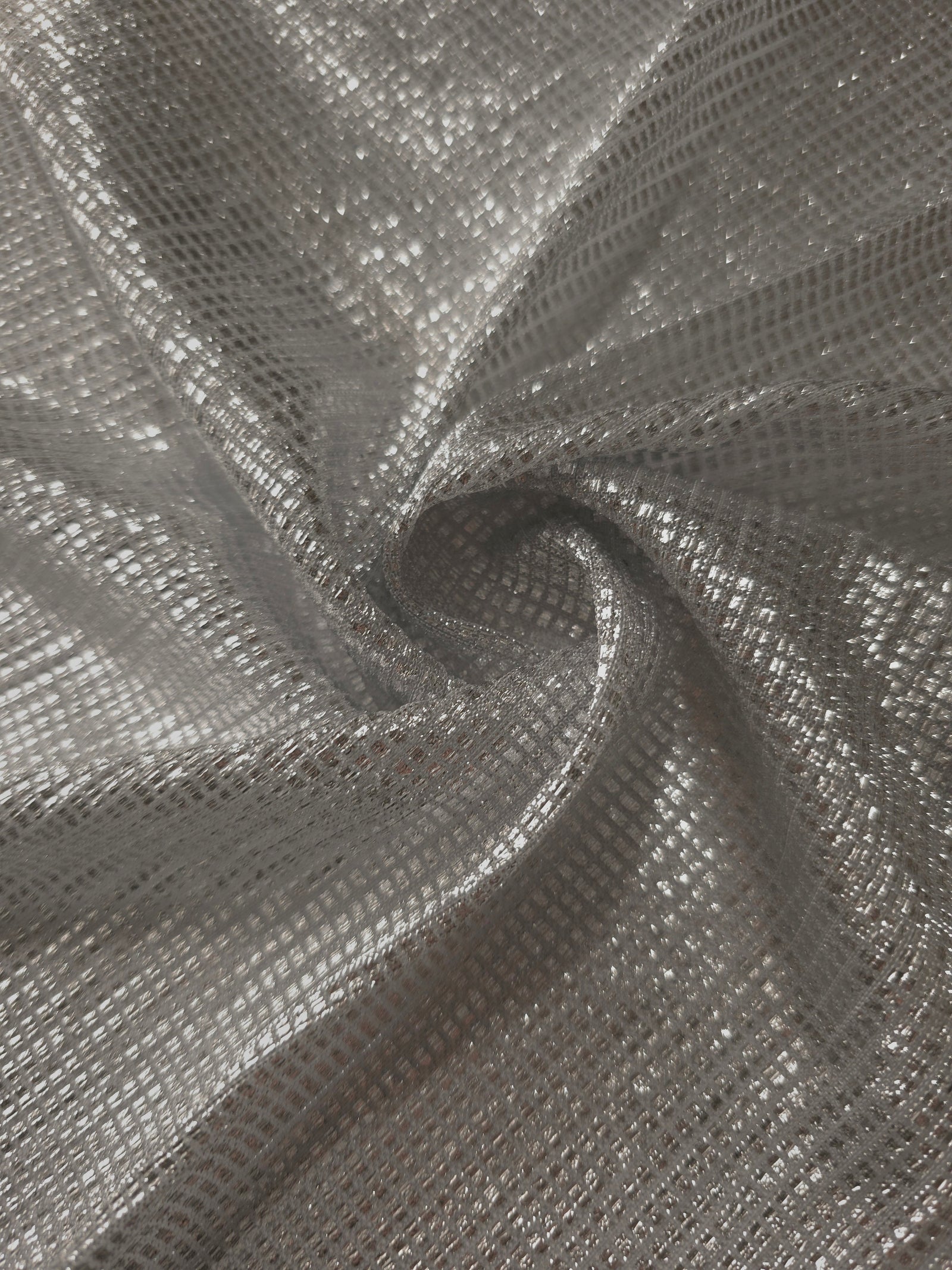 Swirl-draped Silver Gray Sheer Square Shimmer Stretch Tulle Fabric showing structured square reflections moving through soft folds