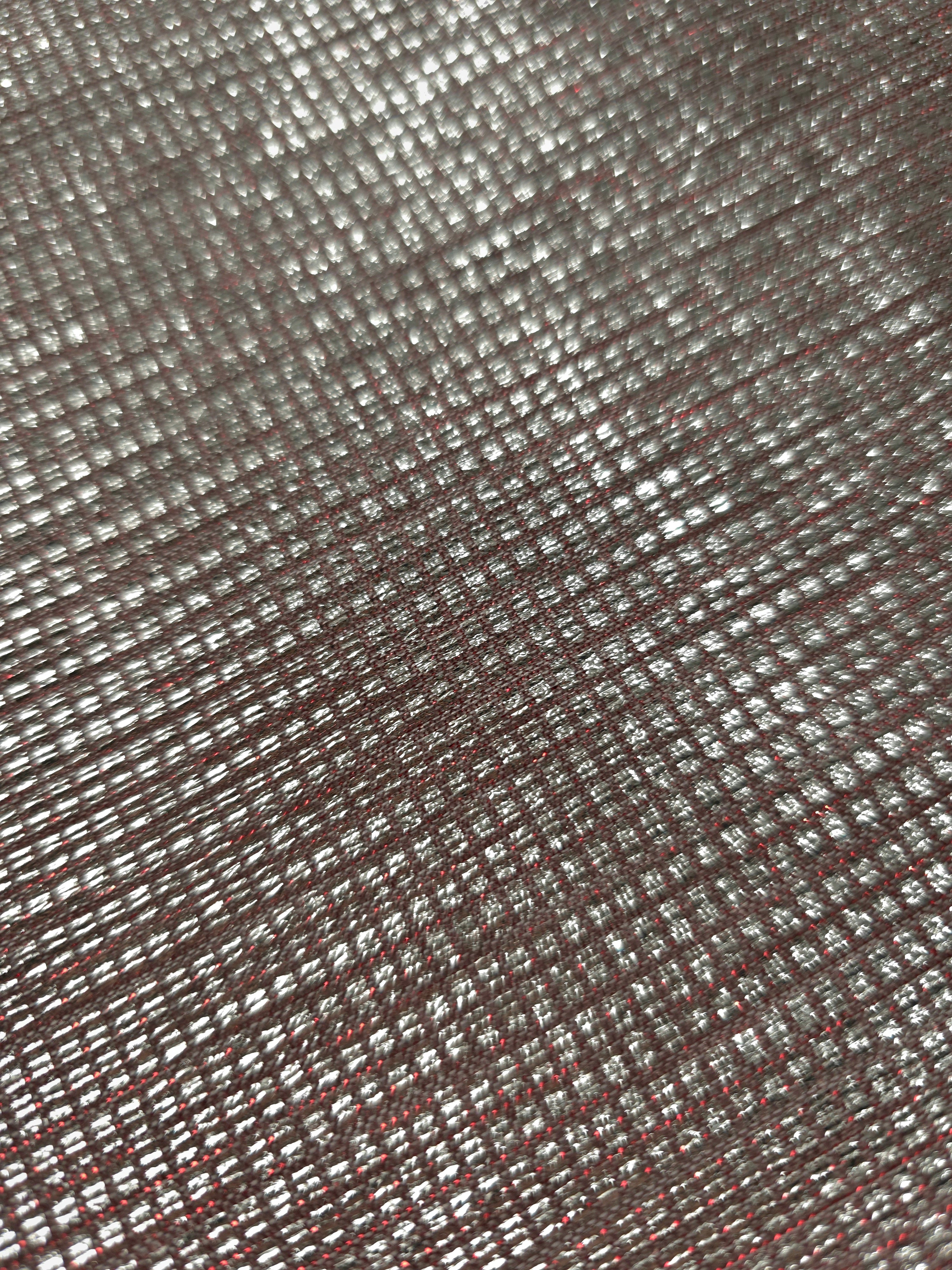 Close-up of Silver Red Sheer Square Shimmer Stretch Tulle Fabric revealing the square shimmer repeat and fine transparent mesh