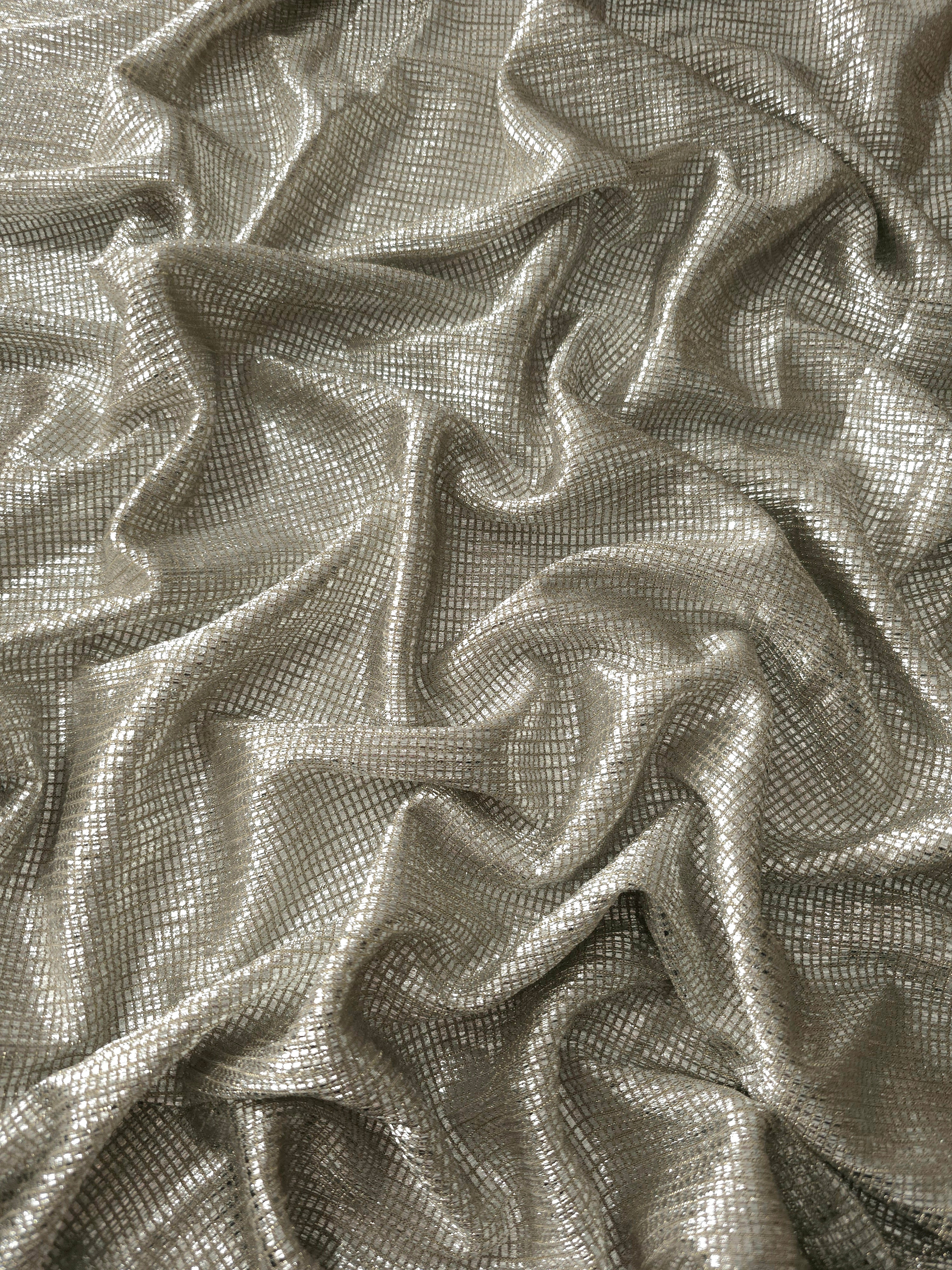 Draped Vanilla Cream Sheer Square Shimmer Stretch Tulle Fabric showing a geometric reflective grid across fluid folds
