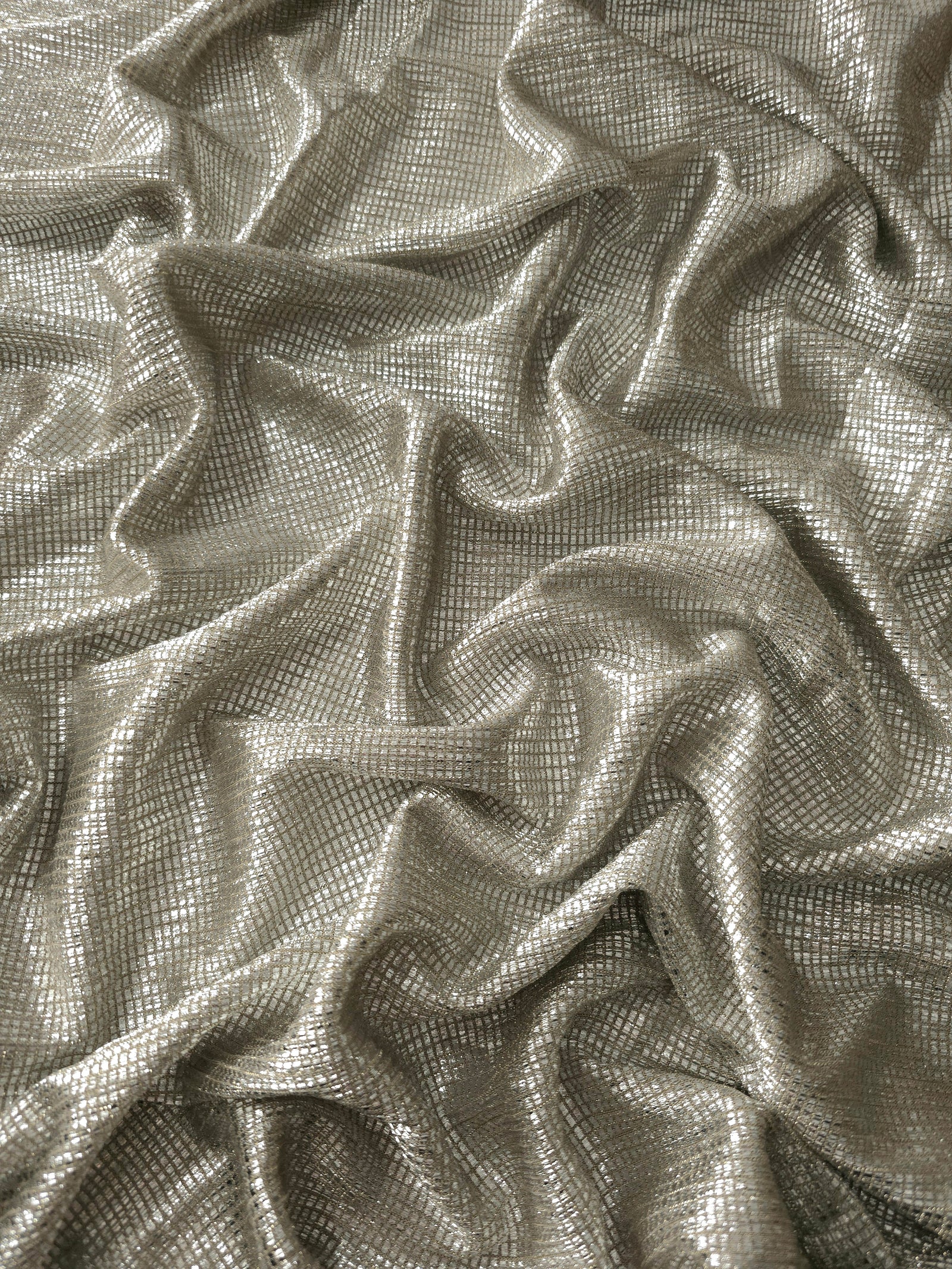 Draped Vanilla Cream Sheer Square Shimmer Stretch Tulle Fabric showing a geometric reflective grid across fluid folds
