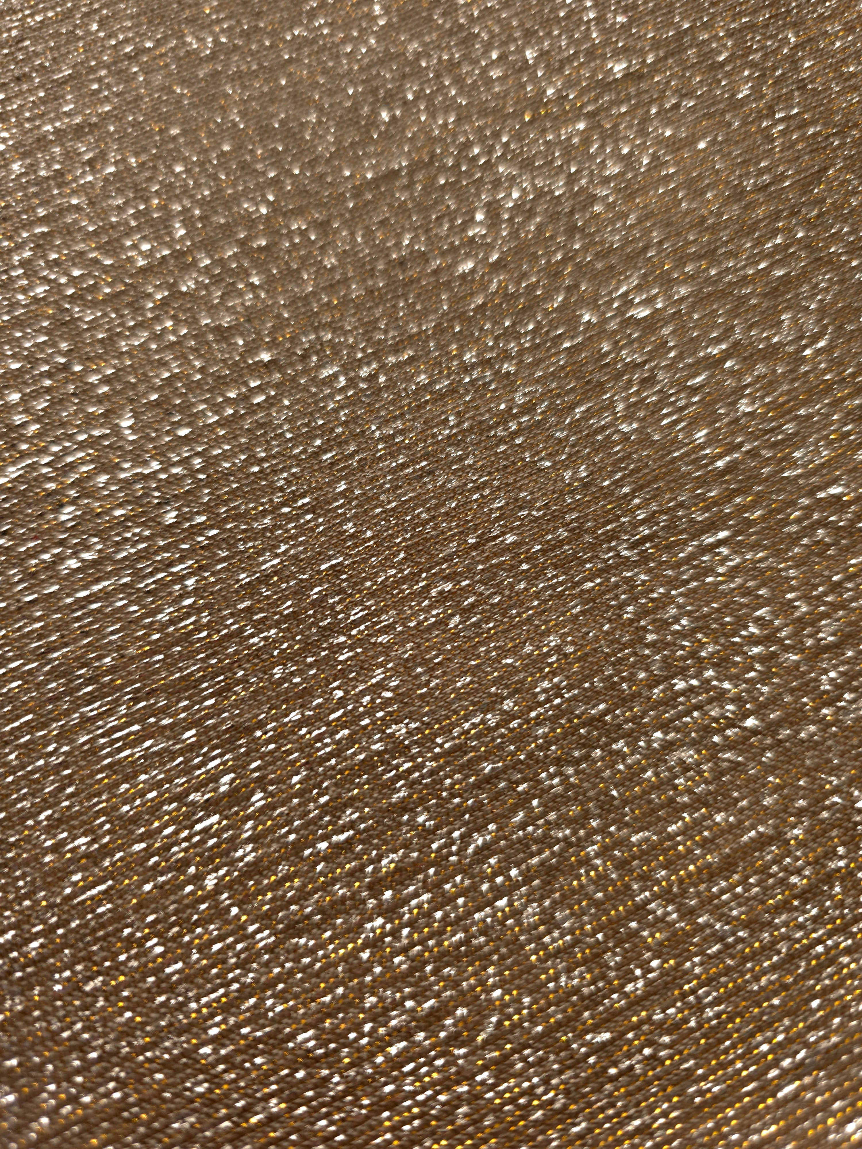Close-up of Antique Gold Sheer Glitter Stretch Tulle Fabric highlighting all-over glitter, fine mesh texture and airy transparency