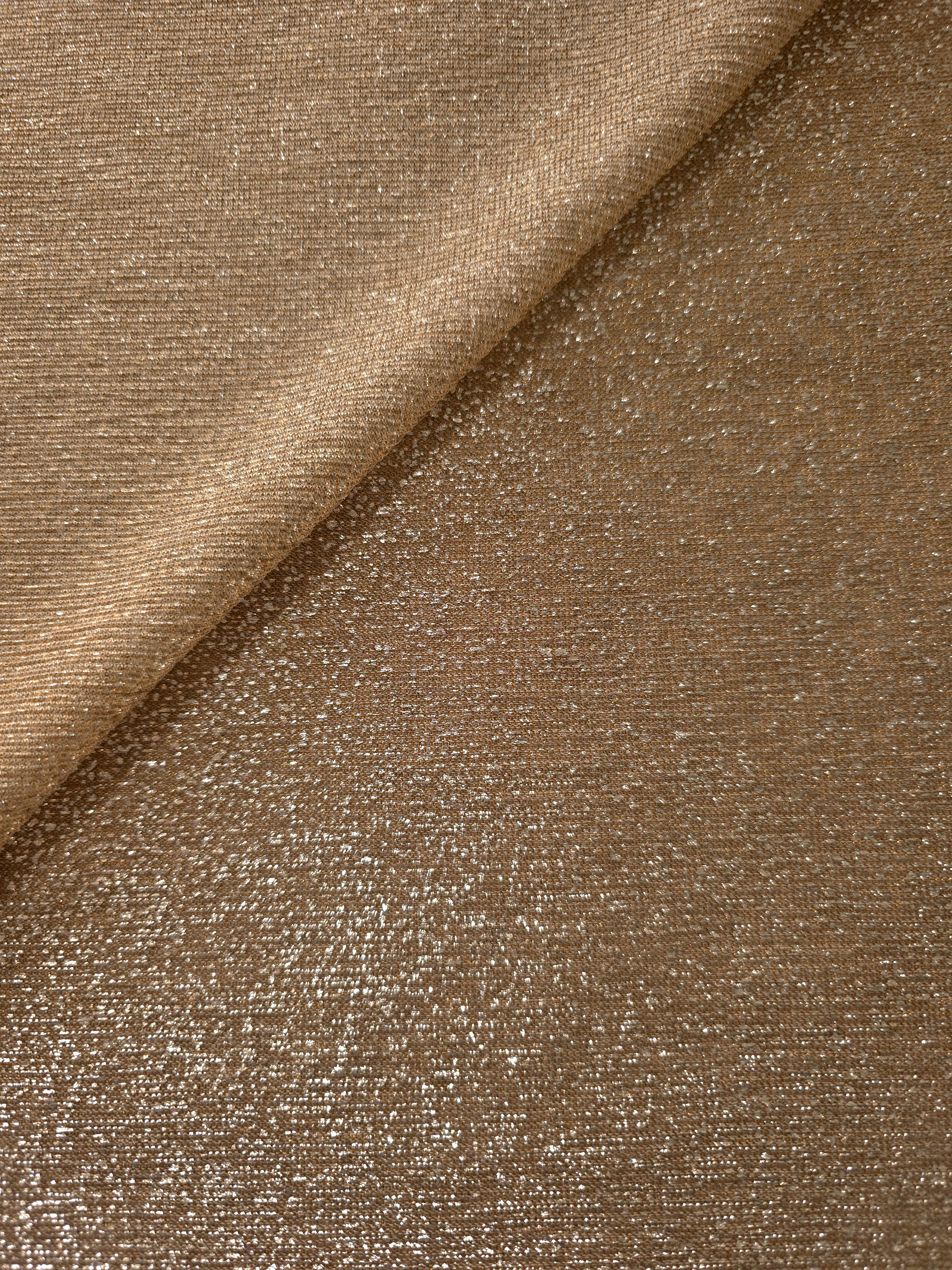 Front and back of Antique Gold Sheer Glitter Stretch Tulle Fabric showing transparent knit construction and flexible 4-way stretch