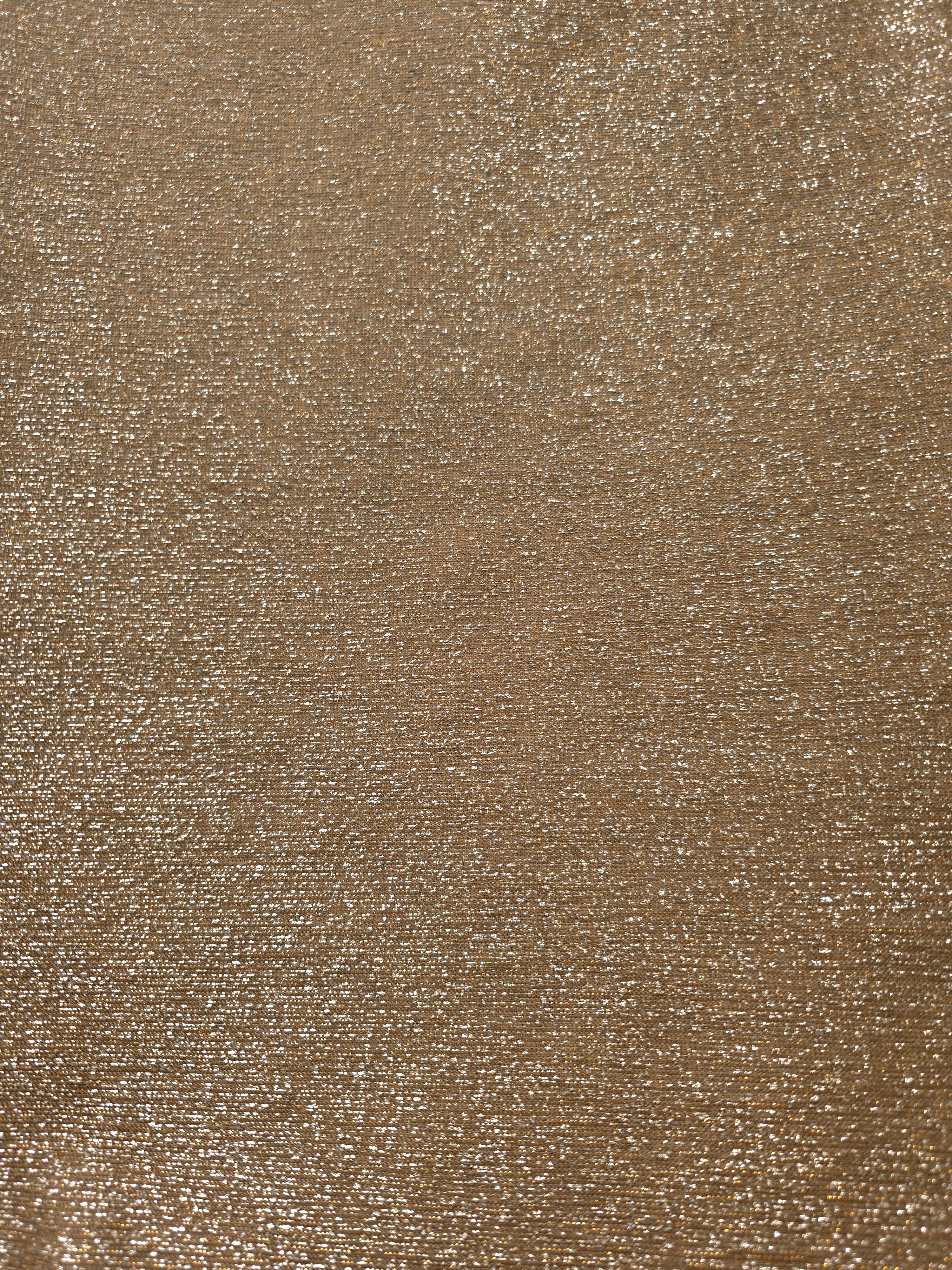 Surface detail of Antique Gold Sheer Glitter Stretch Tulle Fabric showing glitter coverage across the fine sheer tulle base