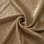 Swirl-draped Antique Gold Sheer Glitter Stretch Tulle Fabric capturing reflective sparkle and fluid movement through flexible folds