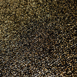 Close-up of Black Gold Sheer Glitter Stretch Tulle Fabric highlighting all-over glitter, fine mesh texture and airy transparency