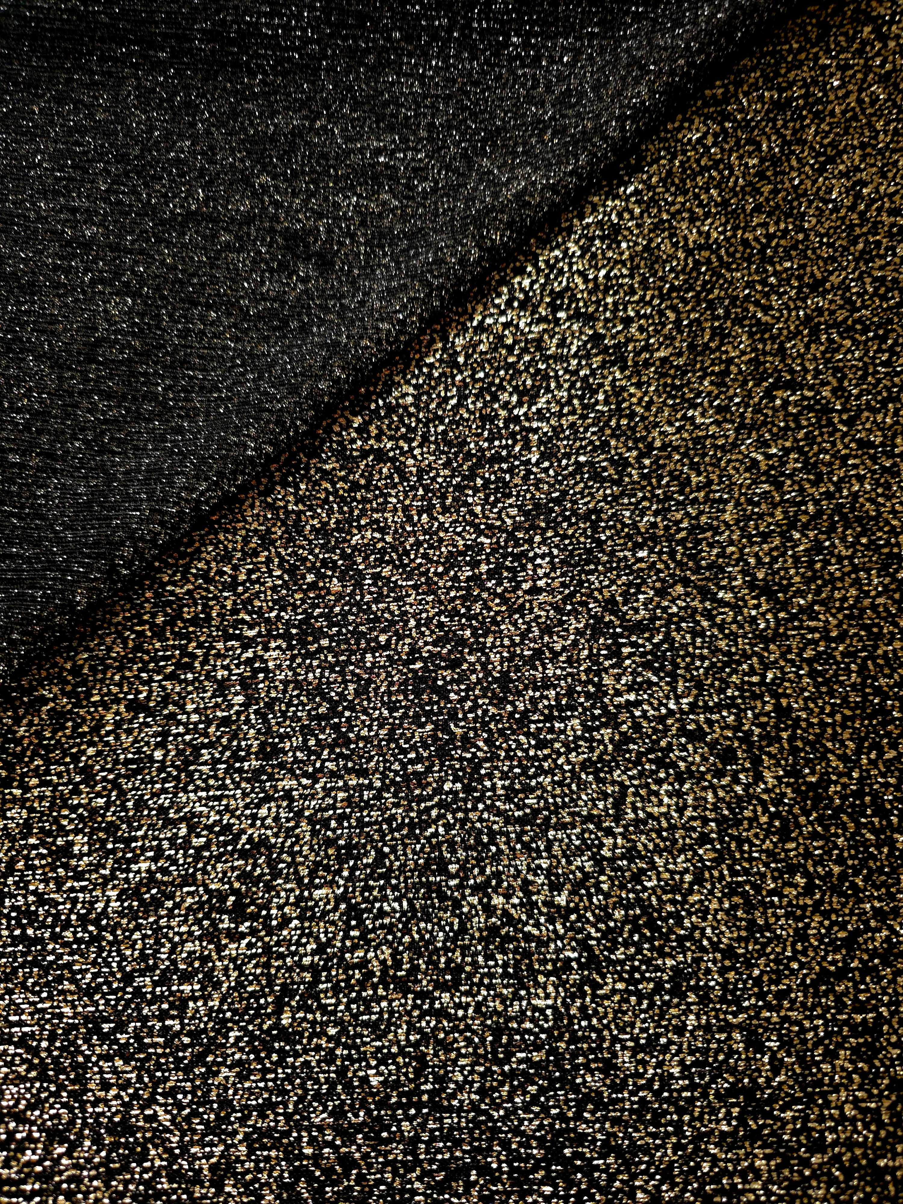 Front and back of Black Gold Sheer Glitter Stretch Tulle Fabric showing transparent knit construction and flexible 4-way stretch