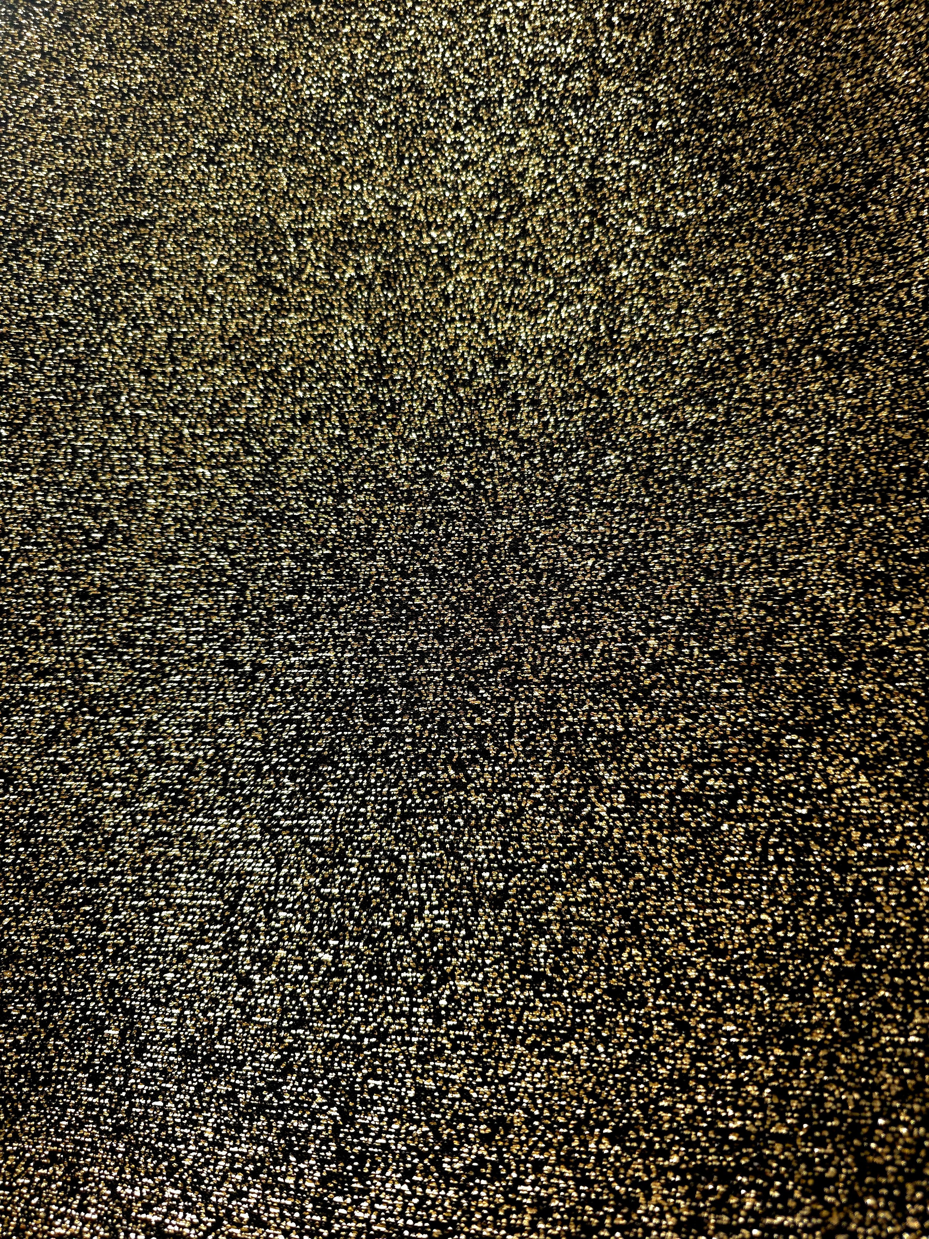 Surface detail of Black Gold Sheer Glitter Stretch Tulle Fabric showing glitter coverage across the fine sheer tulle base