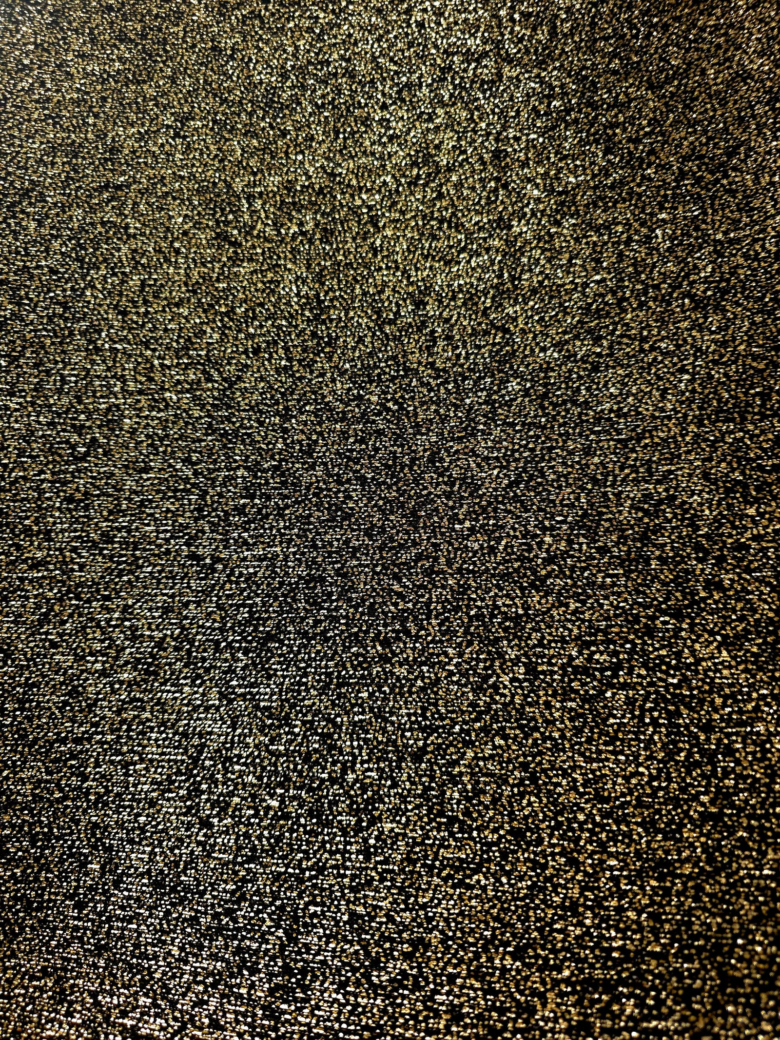 Surface detail of Black Gold Sheer Glitter Stretch Tulle Fabric showing glitter coverage across the fine sheer tulle base