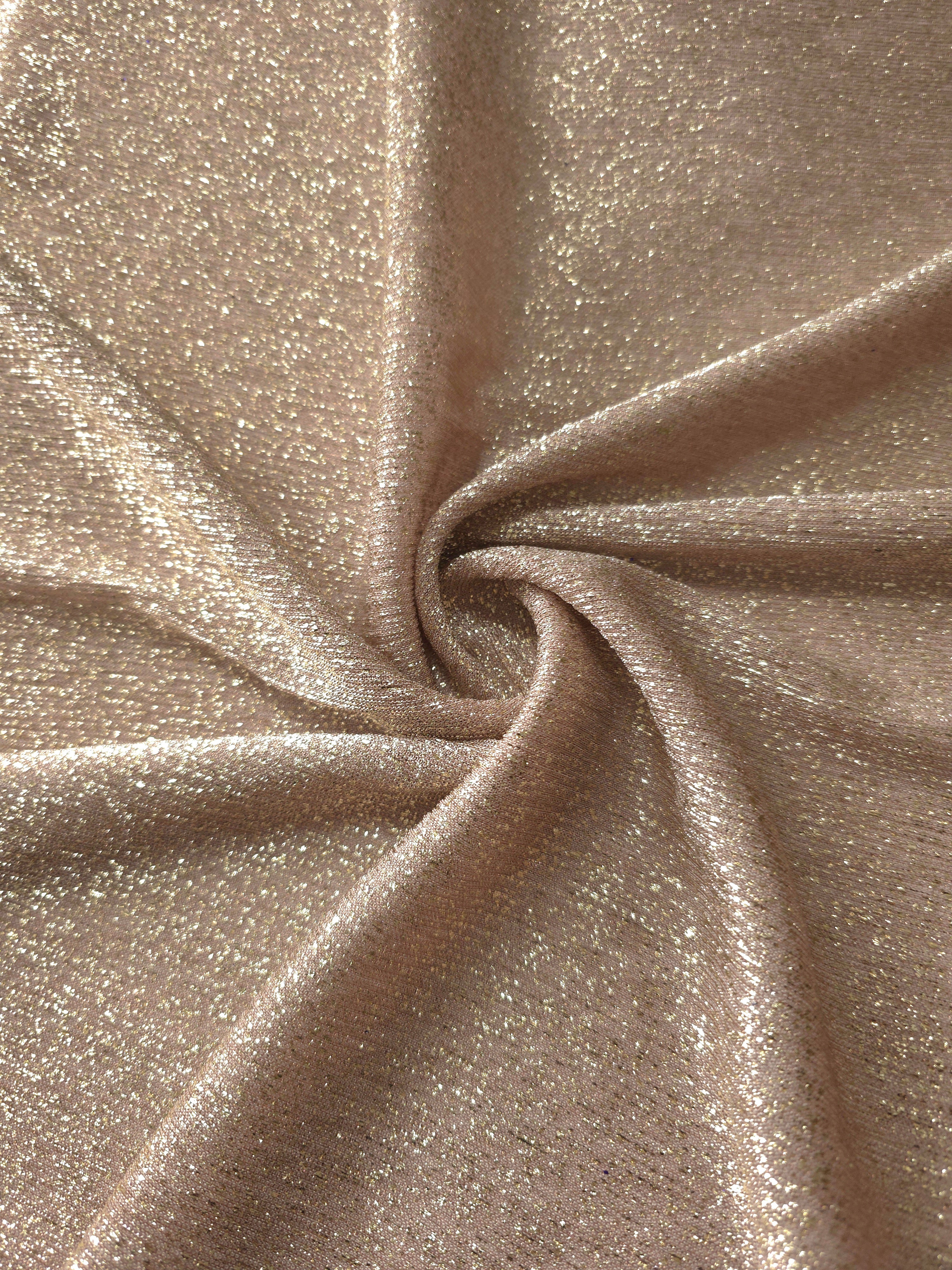 Swirl-draped Champagne Beige Sheer Glitter Stretch Tulle Fabric capturing reflective sparkle and fluid movement through flexible folds
