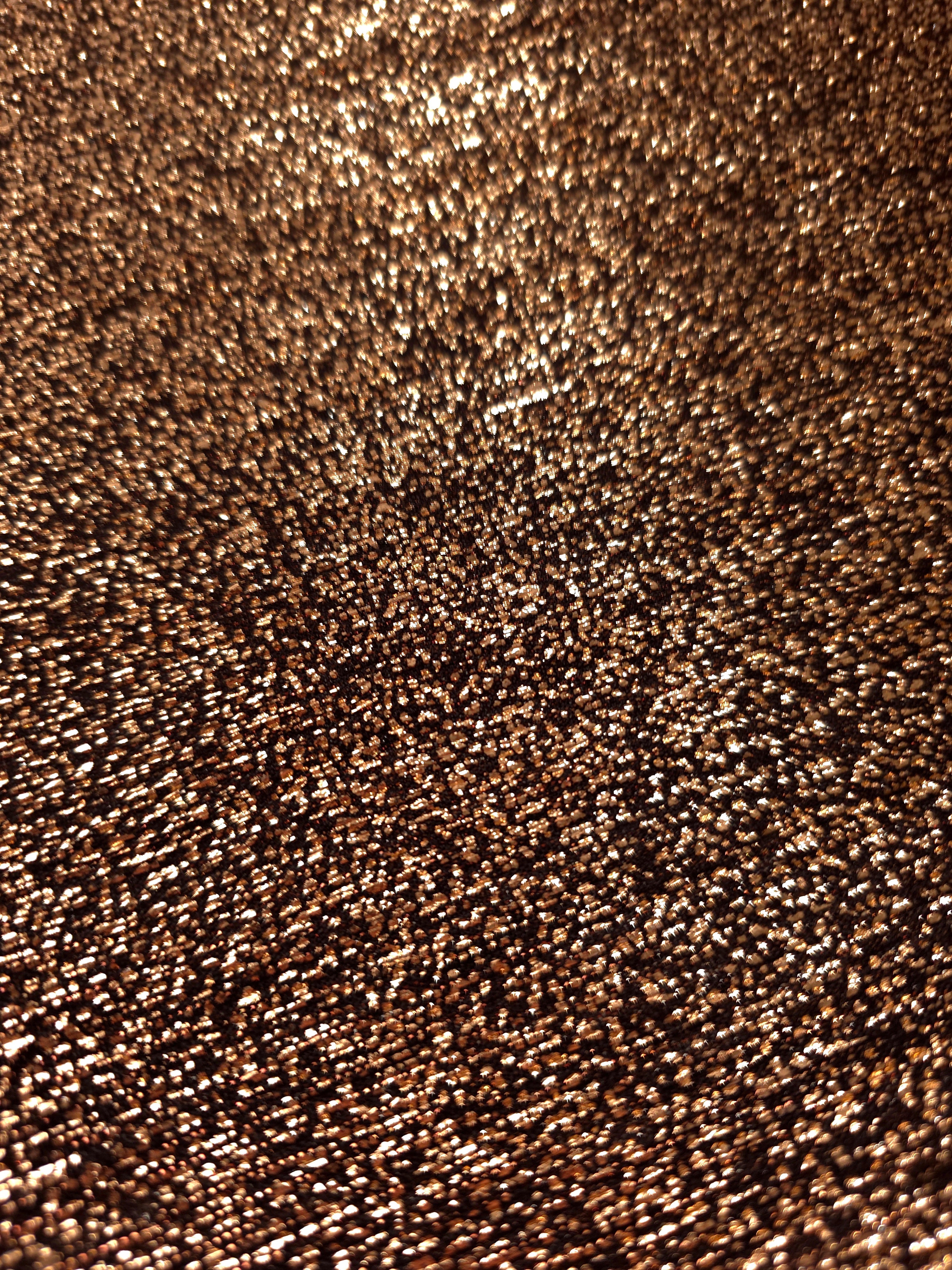 Close-up of Copper Bronze Sheer Glitter Stretch Tulle Fabric highlighting all-over glitter, fine mesh texture and airy transparency
