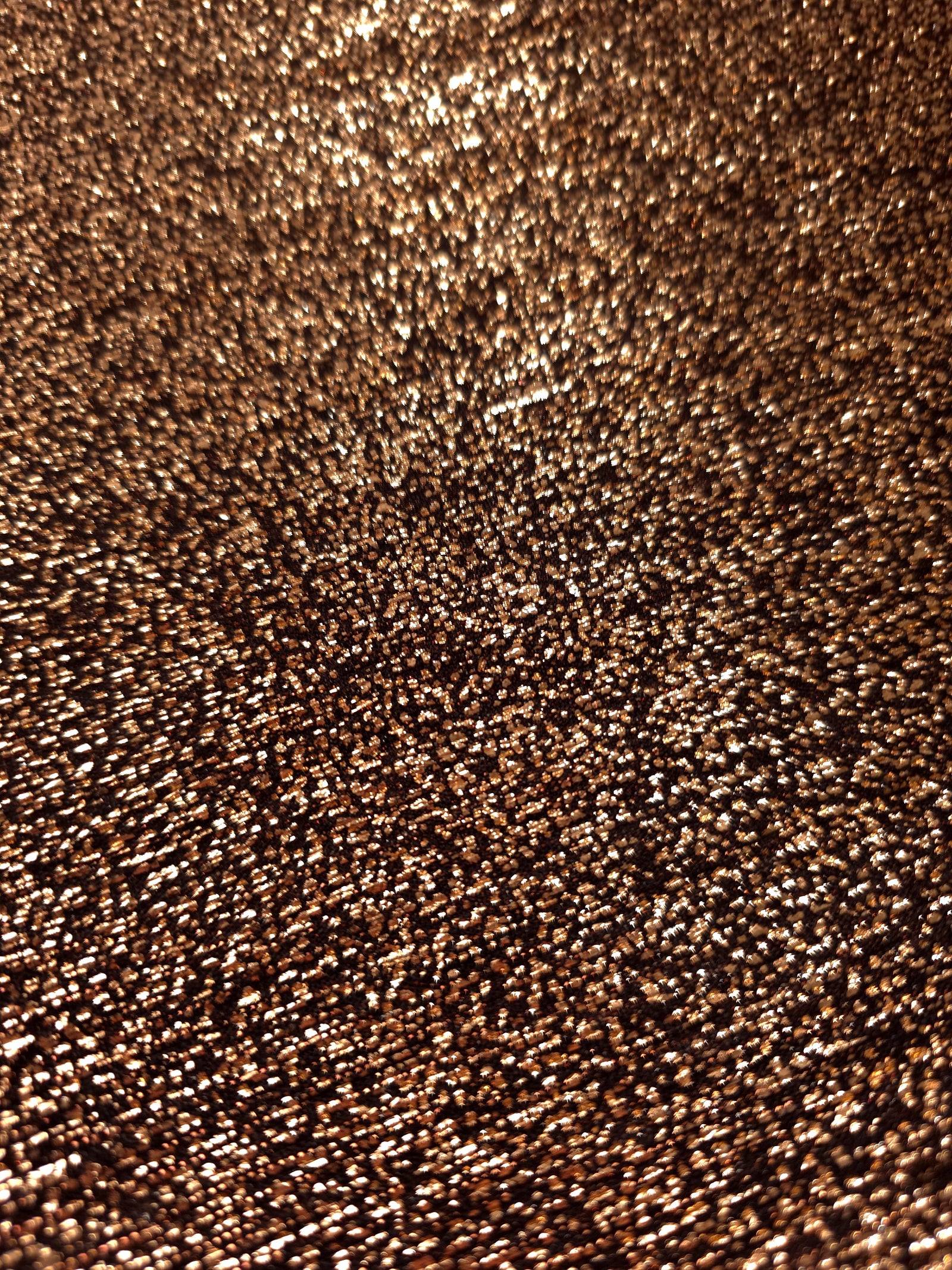 Close-up of Copper Bronze Sheer Glitter Stretch Tulle Fabric highlighting all-over glitter, fine mesh texture and airy transparency