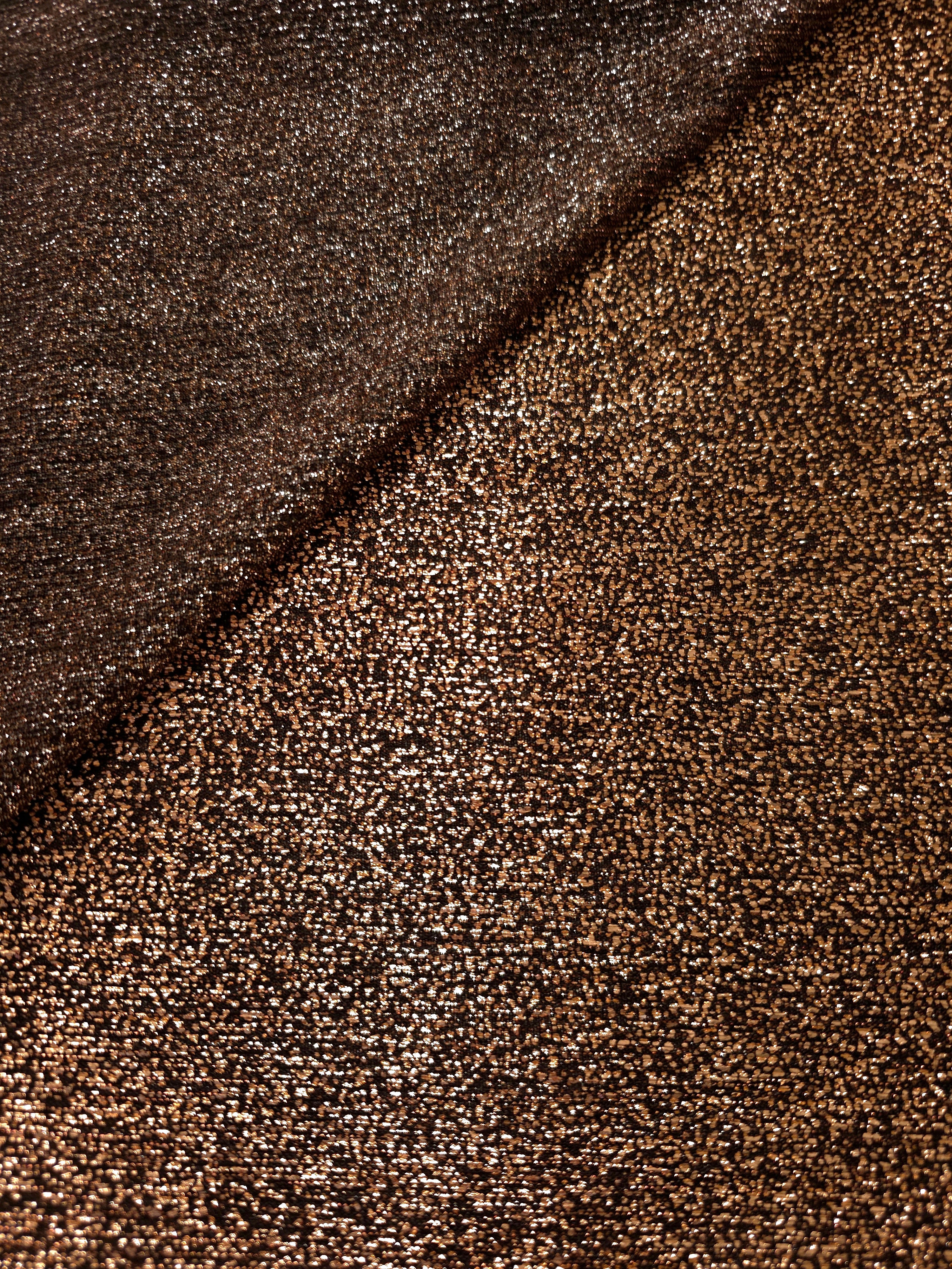 Front and back of Copper Bronze Sheer Glitter Stretch Tulle Fabric showing transparent knit construction and flexible 4-way stretch