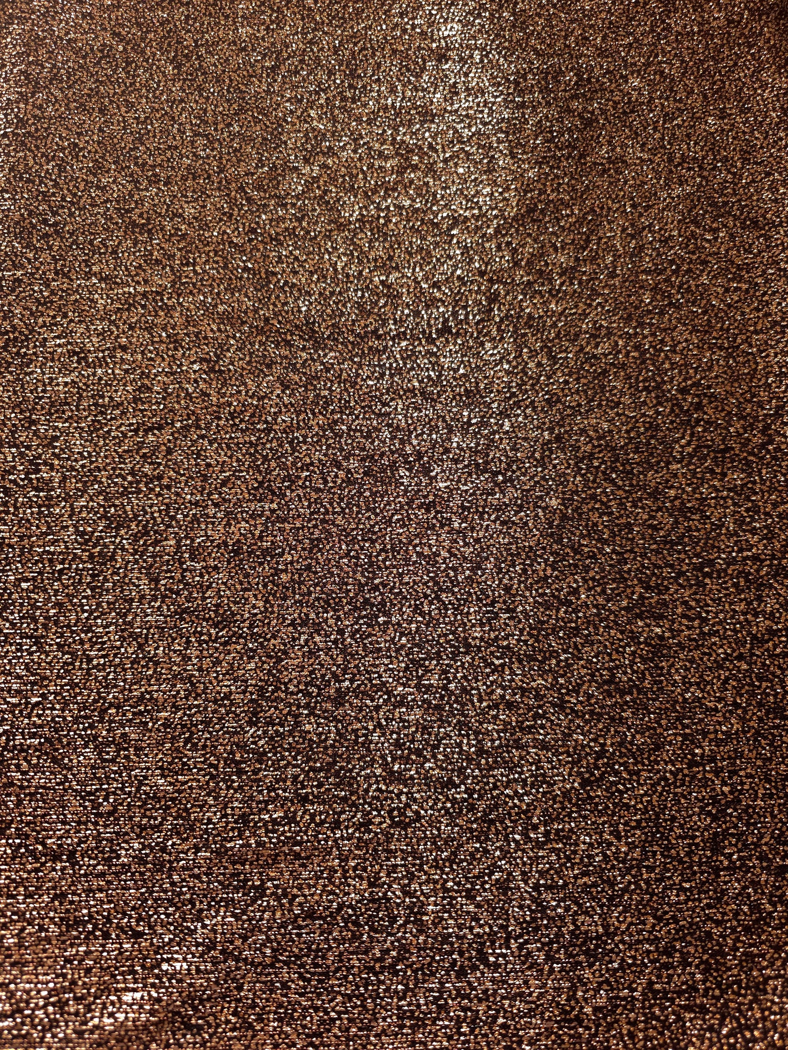 Surface detail of Copper Bronze Sheer Glitter Stretch Tulle Fabric showing glitter coverage across the fine sheer tulle base
