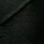 Front and back of Deep Emerald Sheer Glitter Stretch Tulle Fabric showing transparent knit construction and flexible 4-way stretch