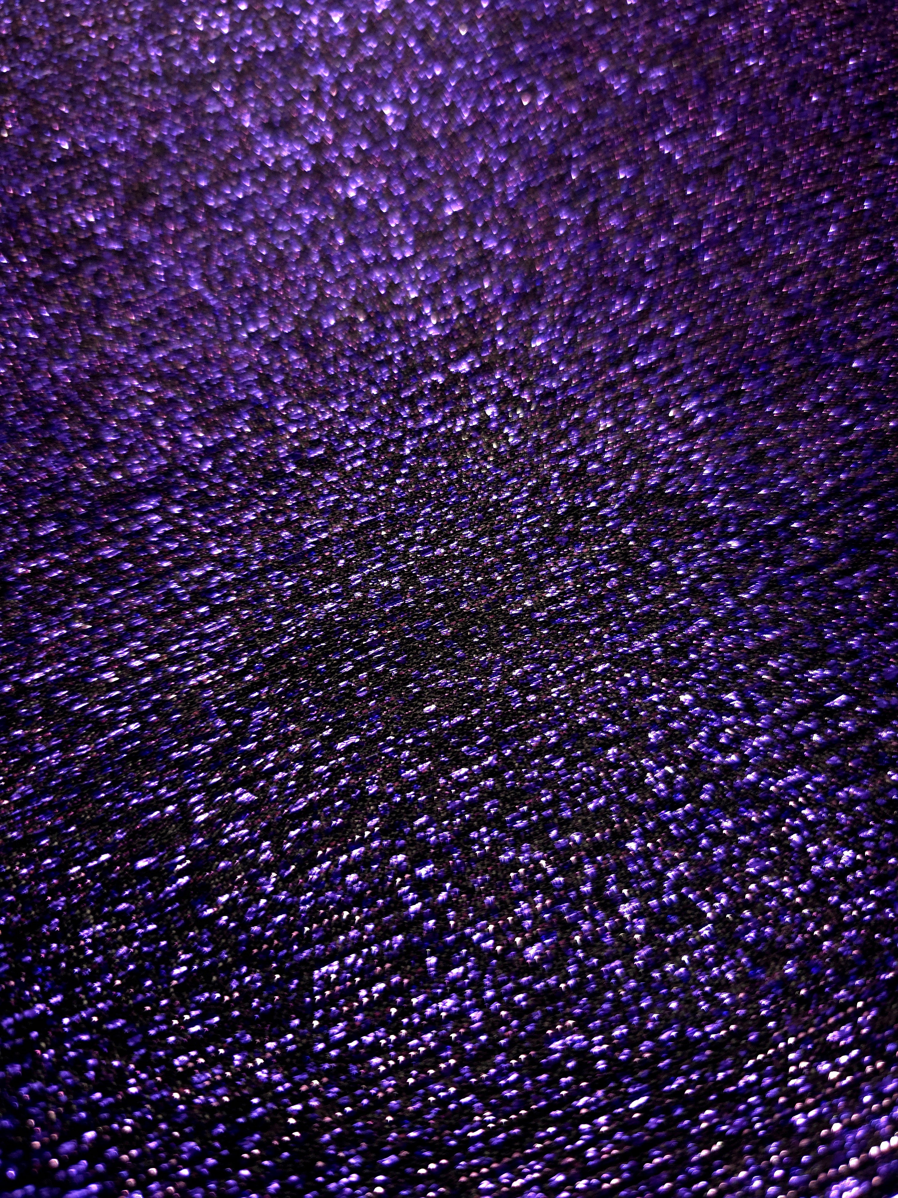 Close-up of Deep Violet Sheer Glitter Stretch Tulle Fabric highlighting all-over glitter, fine mesh texture and airy transparency