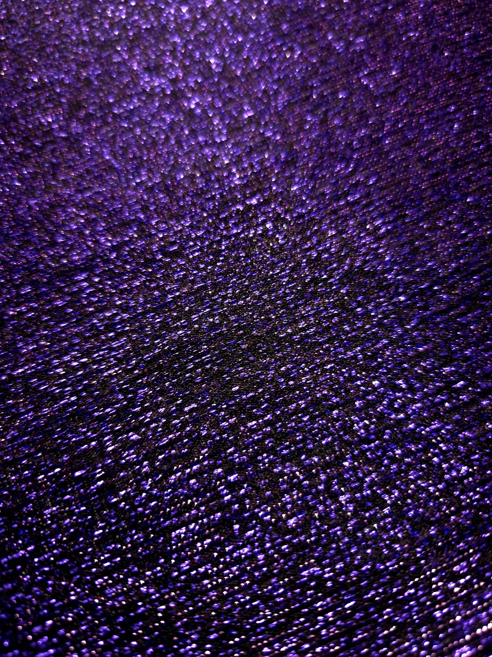Close-up of Deep Violet Sheer Glitter Stretch Tulle Fabric highlighting all-over glitter, fine mesh texture and airy transparency