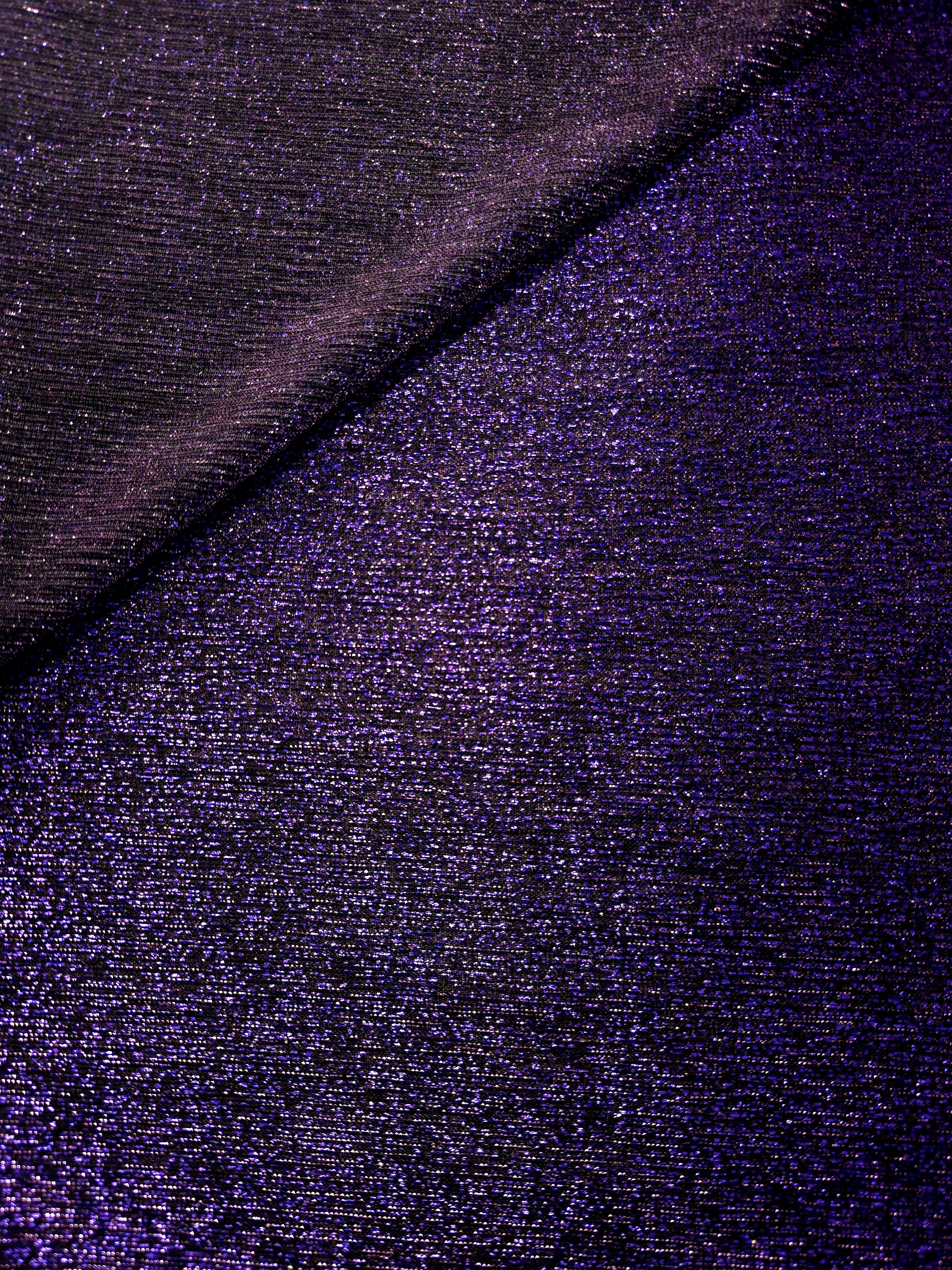 Front and back of Deep Violet Sheer Glitter Stretch Tulle Fabric showing transparent knit construction and flexible 4-way stretch