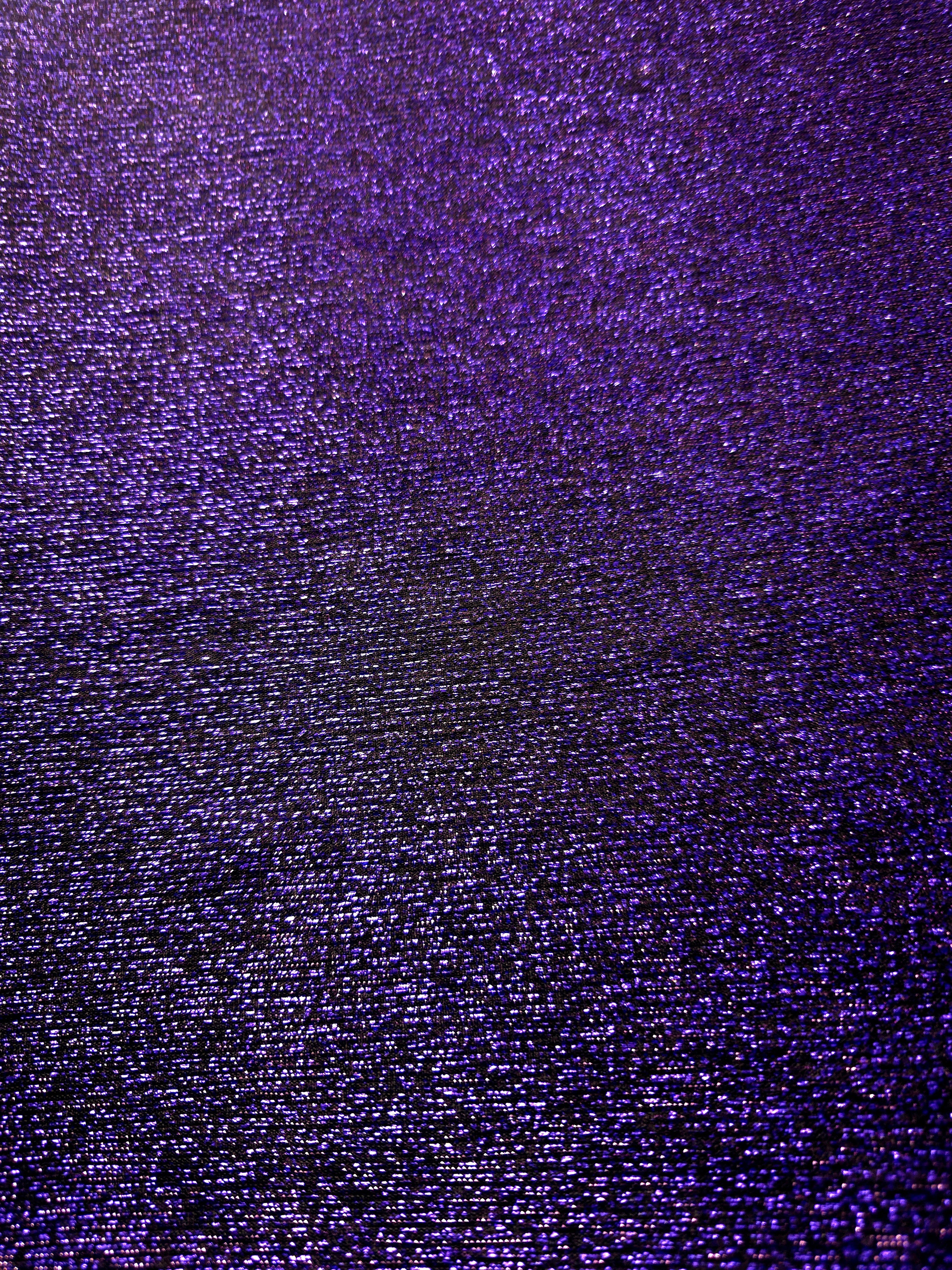 Surface detail of Deep Violet Sheer Glitter Stretch Tulle Fabric showing glitter coverage across the fine sheer tulle base