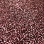 Close-up of Dusty Rose Sheer Glitter Stretch Tulle Fabric highlighting all-over glitter, fine mesh texture and airy transparency