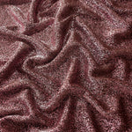 Draped Dusty Rose Sheer Glitter Stretch Tulle Fabric showing scattered sparkle across fluid folds for eveningwear and stage looks