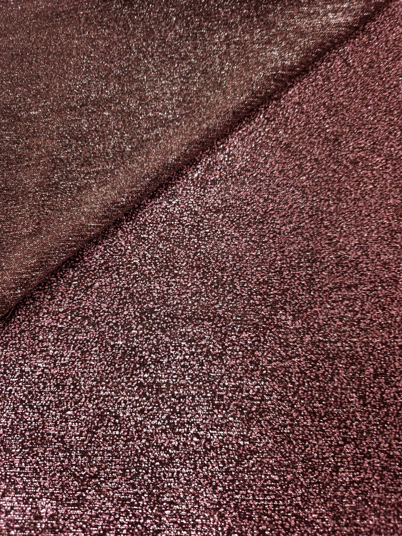 Front and back of Dusty Rose Sheer Glitter Stretch Tulle Fabric showing transparent knit construction and flexible 4-way stretch