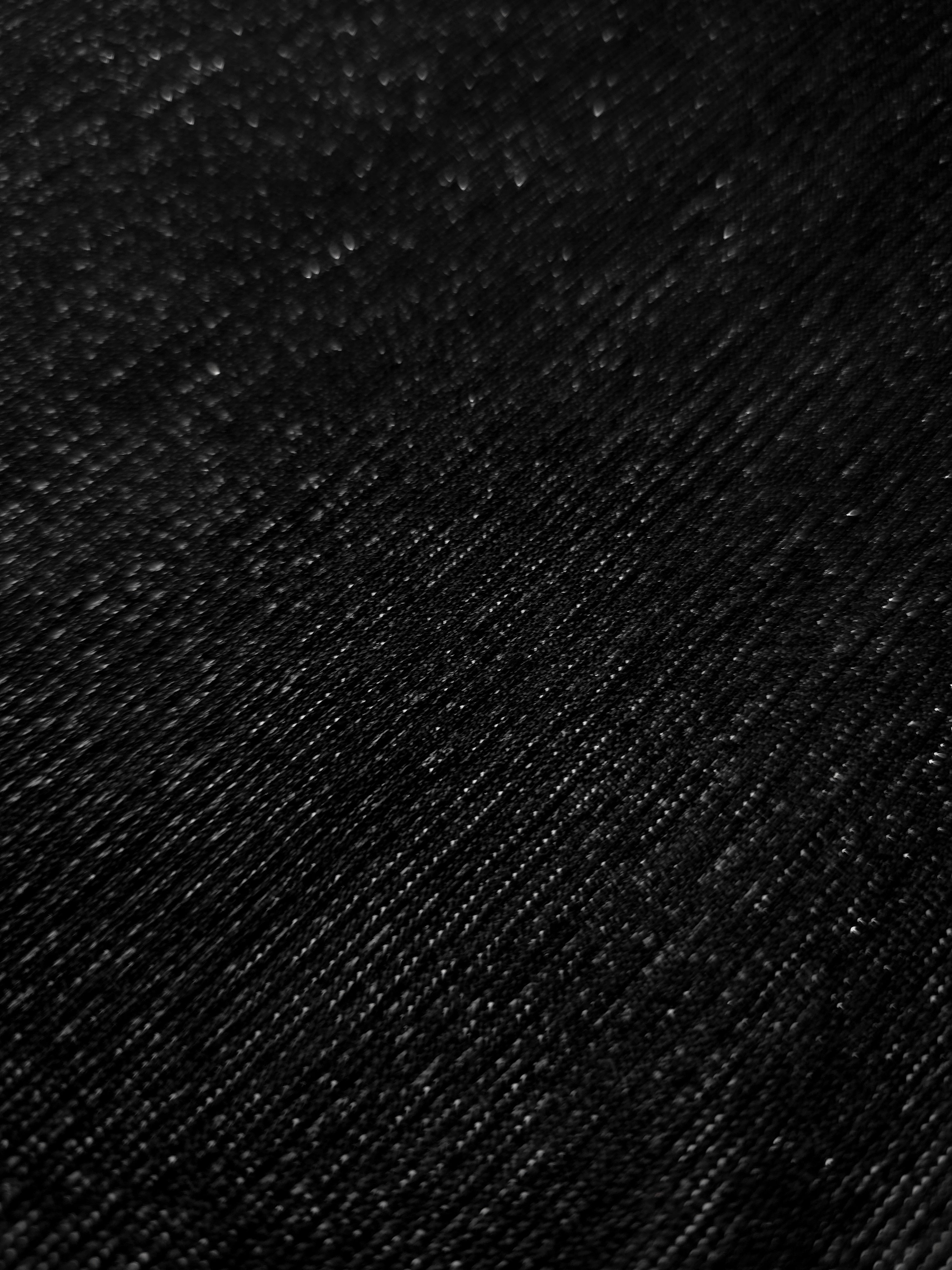 Close-up of Jet Black Sheer Glitter Stretch Tulle Fabric highlighting all-over glitter, fine mesh texture and airy transparency