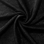 Swirl-draped Jet Black Sheer Glitter Stretch Tulle Fabric capturing reflective sparkle and fluid movement through flexible folds