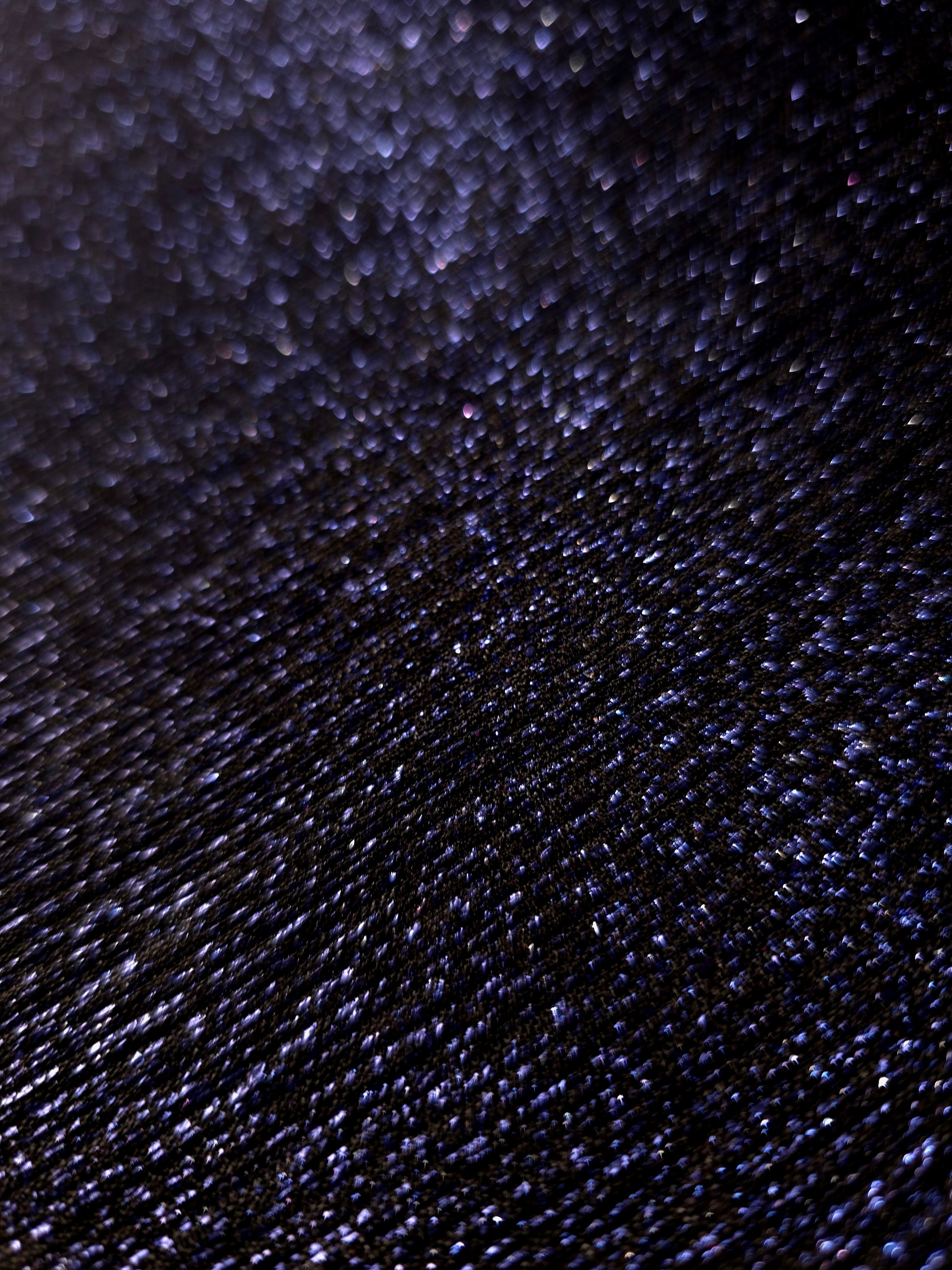 Close-up of Midnight Navy Sheer Glitter Stretch Tulle Fabric highlighting all-over glitter, fine mesh texture and airy transparency